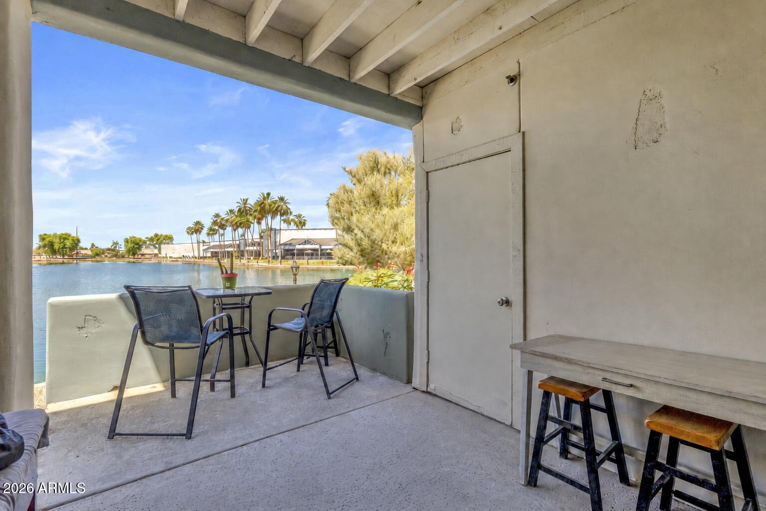 LAKEFRONT CONDO Living in Chandler Near Shopping, Dining & Loop 101! Ground-floor lakefront condo in a gated Chandler community with direct water views, private patio access, and resort-style amenities near Dobson Rd & Ray Rd. This remodeled 2-bedroom, 2-bath condo offers approximately 897 sq ft and covered patio overlooking the lake, plus exterior storage space. Fishing and boating are permitted on the community lake, creating a unique waterfront lifestyle in the heart of Chandler. Interior upgrades completed in 2022 include wood-look tile flooring throughout, refinished cabinetry, Dunn-Edwards interior paint, LED lighting, faux wood blinds, updated fixtures, and remodeled bathrooms. The kitchen features quartz-look countertops, gray shaker-style cabinets, black appliances microwave, dishwasher, refrigerator, and glass-top range. Full-size washer and dryer included. The primary suite offers lake views, a large walk-in closet, detached vanity area, and a remodeled walk-in shower with multiple shower heads including a rain shower feature and upgraded Moen fixtures. Guest bath includes a 5-foot soaking tub and updated vanity. Sliding glass doors open directly to the covered patio overlooking the lake, ideal for outdoor dining, relaxing, or enjoying sunset water views. Community amenities include 3 swimming pools, fitness center, tennis courts, BBQ areas, walking/jogging paths around the lake, covered parking, and gated entry. Additional updates include new HVAC and water heater installed in 2024. HOA covers water, sewer, and trash.
Located 0.3 miles to Fry's Marketplace, 0.4 miles to Sprouts Farmers Market, 0.5 miles to Pita Jungle, 1.5 miles to Loop 101 access, 2.0 miles to Chandler Fashion Center, and 3.5 miles to Intel's Chandler campus. Convenient access to dining, shopping, parks, golf, and major employment corridors throughout Chandler and the East Valley!