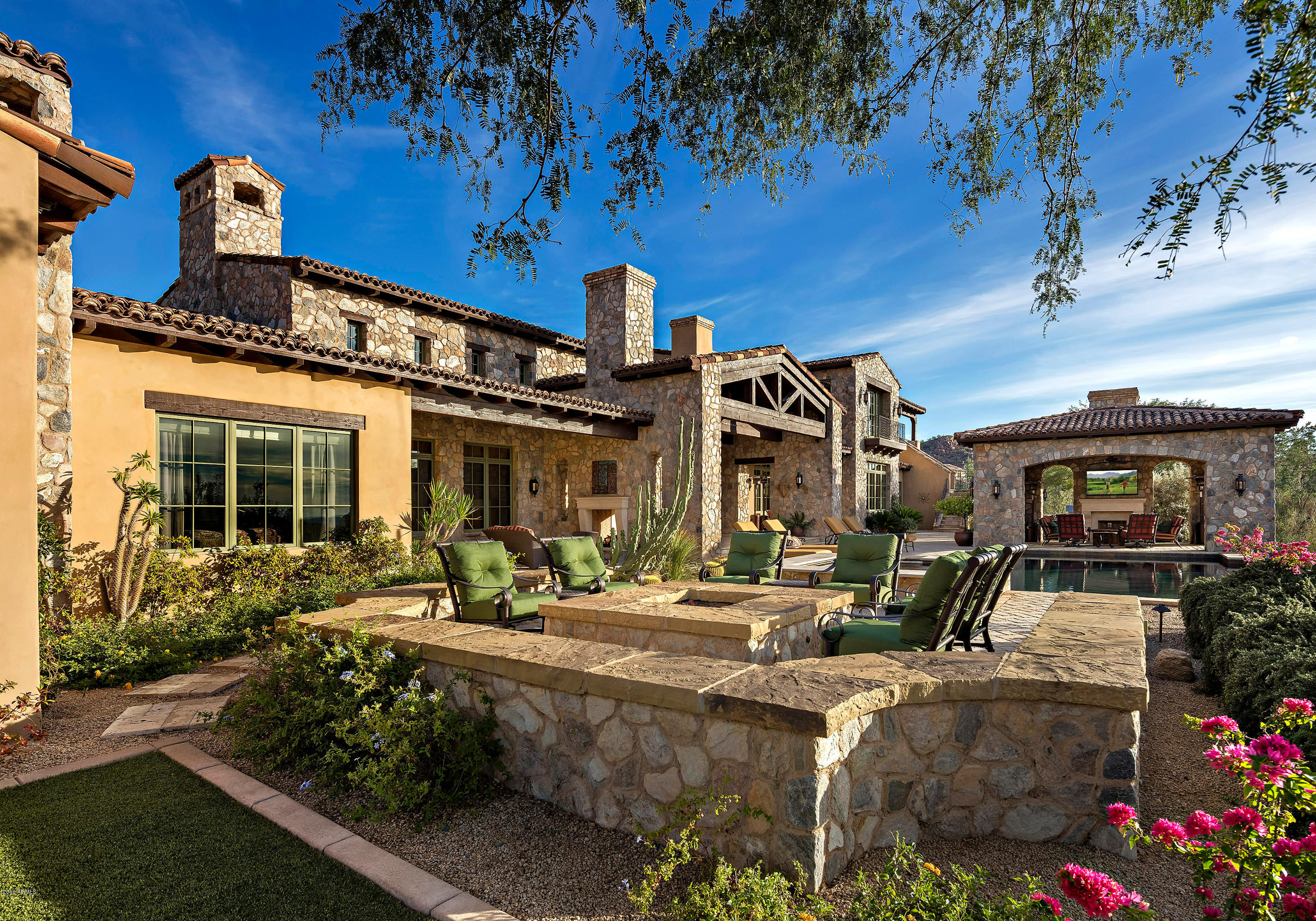 This spectacular Calvis Wyant estate nestled in the exclusive Upper Canyon of Silverleaf might just have it all. Breathtaking views of the city, sunsets and surrounding mountains are truly amazing. The home’s floor-plan with over 11,000 sq. ft. boasts amenities and finishes that are of superb quality with uncompromised attention to detail. Features include 6 bedrooms, 8 baths, private detached Casita, gourmet custom kitchen with catering entrance, large laundry/craft room, lush landscaping, game room, pool, spa and outdoor kitchen, multiple fireplaces and water features, theatre, elaborate wine cellar with custom corked flooring, wood paneled office, and elevator for easy access. Front courtyard offers water feature, fireplace, and mountain & sunrise views. The Casita offers its own private courtyard, suite, and spectacular views. An enormous amount of thought and detail went into the planning of this home, come see for yourself!