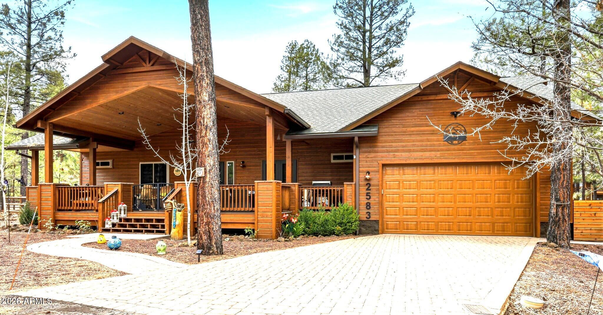 **Seller Financing Available** Come see the Pinetop Cabin you have been waiting for!  Beautifully maintained, spacious 3-bedroom, 2-bath retreat is ideally situated on a private cul-de-sac lot within a Gated community. Designed for comfortable mountain living & effortless entertaining, the home features an oversized covered front patio, paver driveway, and thoughtfully landscaped. The brand-new kitchen remodel showcases high-end GE Café appliances, including a microwave drawer, double oven, and gas range. Custom solid wood cabinetry offers premium features such as a stand mixer lift shelf, open shelving, and backlit glass upper cabinets. Designer chandelier highlights the dining area, where French doors open seamlessly to the covered porch-- perfect for enjoying cool mountain evenings. Inside, the open great room boasts vaulted knotty pine tongue-and-groove ceilings, luxury vinyl plank flooring, and a cozy gas fireplace. The generous primary suite also features its own gas fireplace, along with dual granite vanities, a walk-in shower, and an oversized walk-in closet.
Guest accommodations include a king-sized secondary bedroom, a third guest room, and a guest bath with granite dual vanities and a tiled tub/shower combo in a separate area for added functionality.

Additional features include cabinetry and a built-in workstation in the 2-car garage. The fully fenced backyard is designed for privacy and enjoyment, complete with artificial turf, mature trees, paver walkways and patio, seating area with firepit potential, covered rear patio, raised garden bed, double gate access, and a Kohler generator for added peace of mind.
This exceptional property blends modern upgrades with rustic charm in a highly desirable gated setting. Owner May Carry