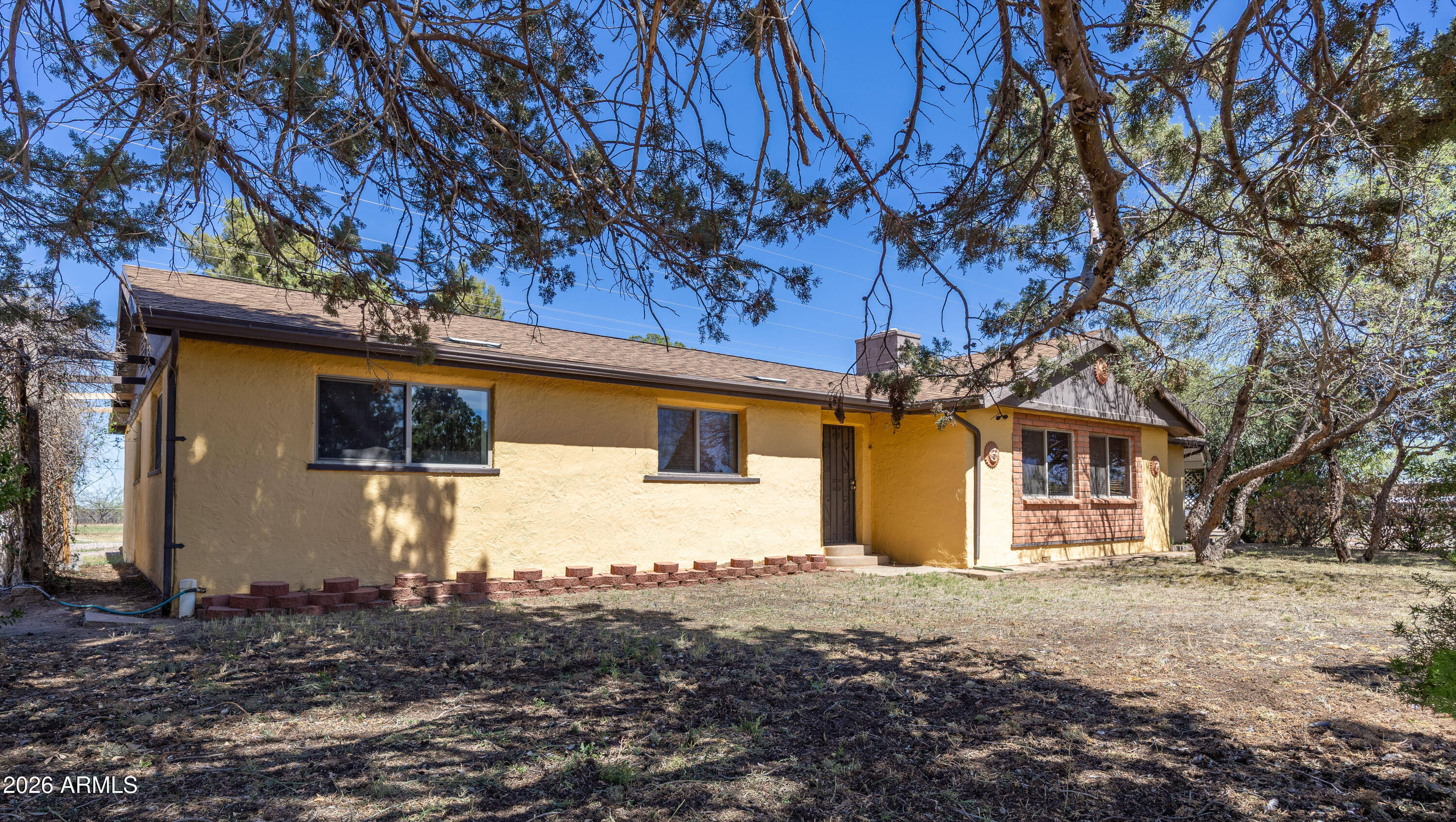 An acre with its own well, fully fenced and cross fenced with chain link. Home has a southwestern vibe with lots of space to enjoy. 2 fire places and a wood stove in family room. Detached 2 car garage. Workshop aprox 14 by16 with electric. 3 bay pole barn next to tall covered parking for RV with electric. Well done kitchen with trash compactor, gas range, wall oven, dishwasher. pantry. Big laundry room/mudroom off of carport into kitchen.  New roof in May 2024 with 5 year warranty on workmanship.  Solar tubes and new skylights. Very flexable floorplan. Family room was set up for pool table. Storage shed.  Keysafe on morning of 25th.