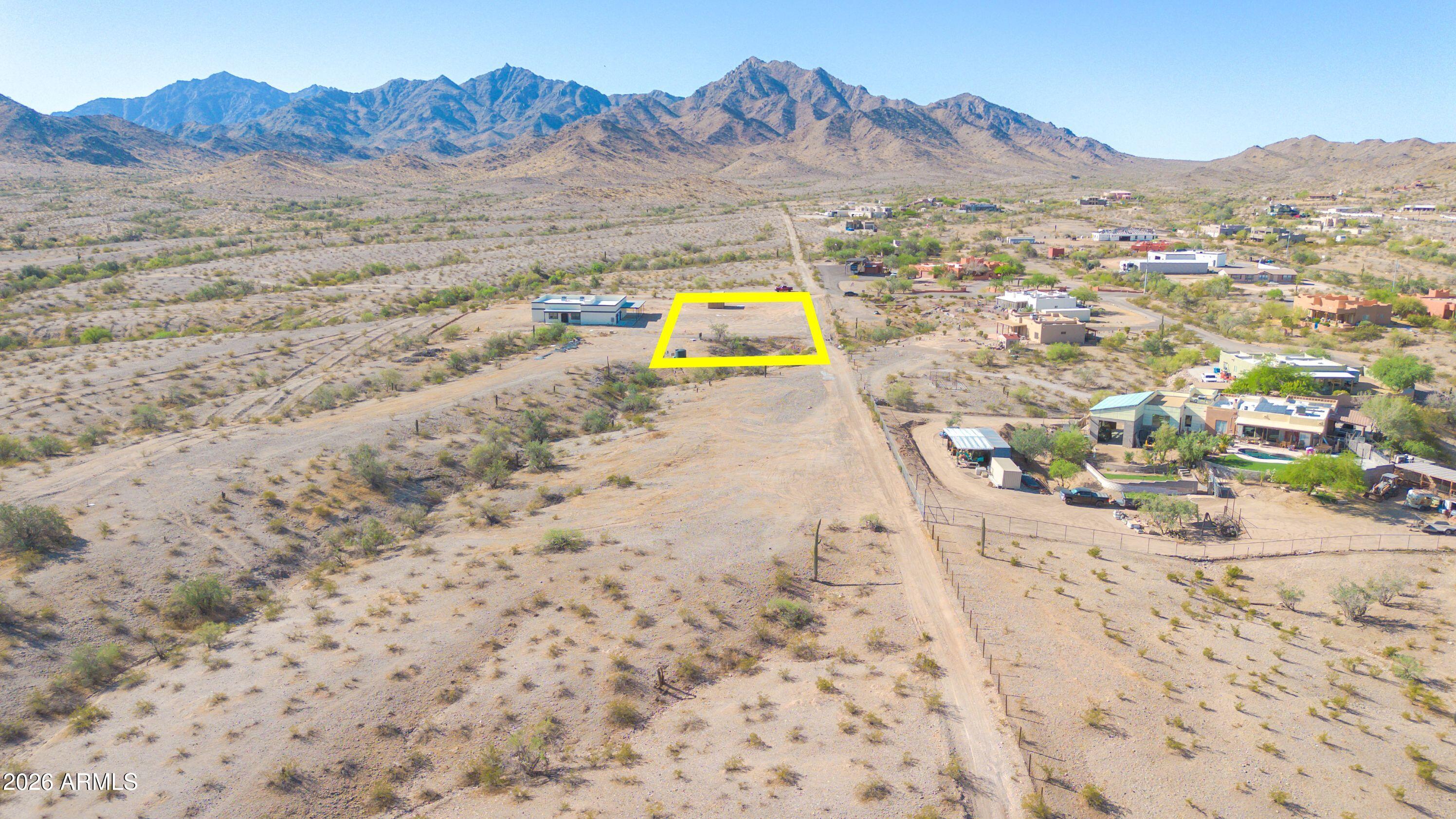 Prime 1-acre parcel offering outstanding views and exceptional privacy. The unobstructed views, create the perfect setting for a custom home with desert scenery and gorgeous views of the Estrella mountains. The majority of the lot is flat, with a wash running through the north end. A recorded, shared well deed is included. Electricity is adjacent to this parcel, and there is no HOA. This is a rare opportunity to secure a premium building parcel with remarkable views, privacy, and essential utilities close by. Walk the property and experience its beauty and the incredible views of the Estrella mountains in person. The property has rights to a shared water well with pump installed and storage tank. There are many possibilities with this land, while still enjoying these incredible views.