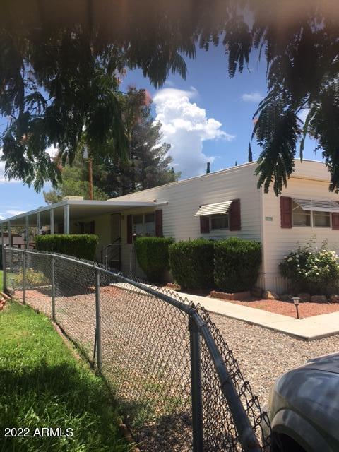 This impeccably taken care of ,and adorable 2bd 1 1/2 bth is move in ready. It is nestled in its own landscaped yard. It has full kitchen with range ,dishwasher and refrigerator. It comes with washer and dryer .Has built in dressers in both rooms. It has 2 large sheds  and 1 other shed for storage. It has ramp for wheelchair accessibility .Large covered cement porch the length of residence and covered parking. Mature, well kept landscaping. A true gem at this price ! Home is being sold AS IS.