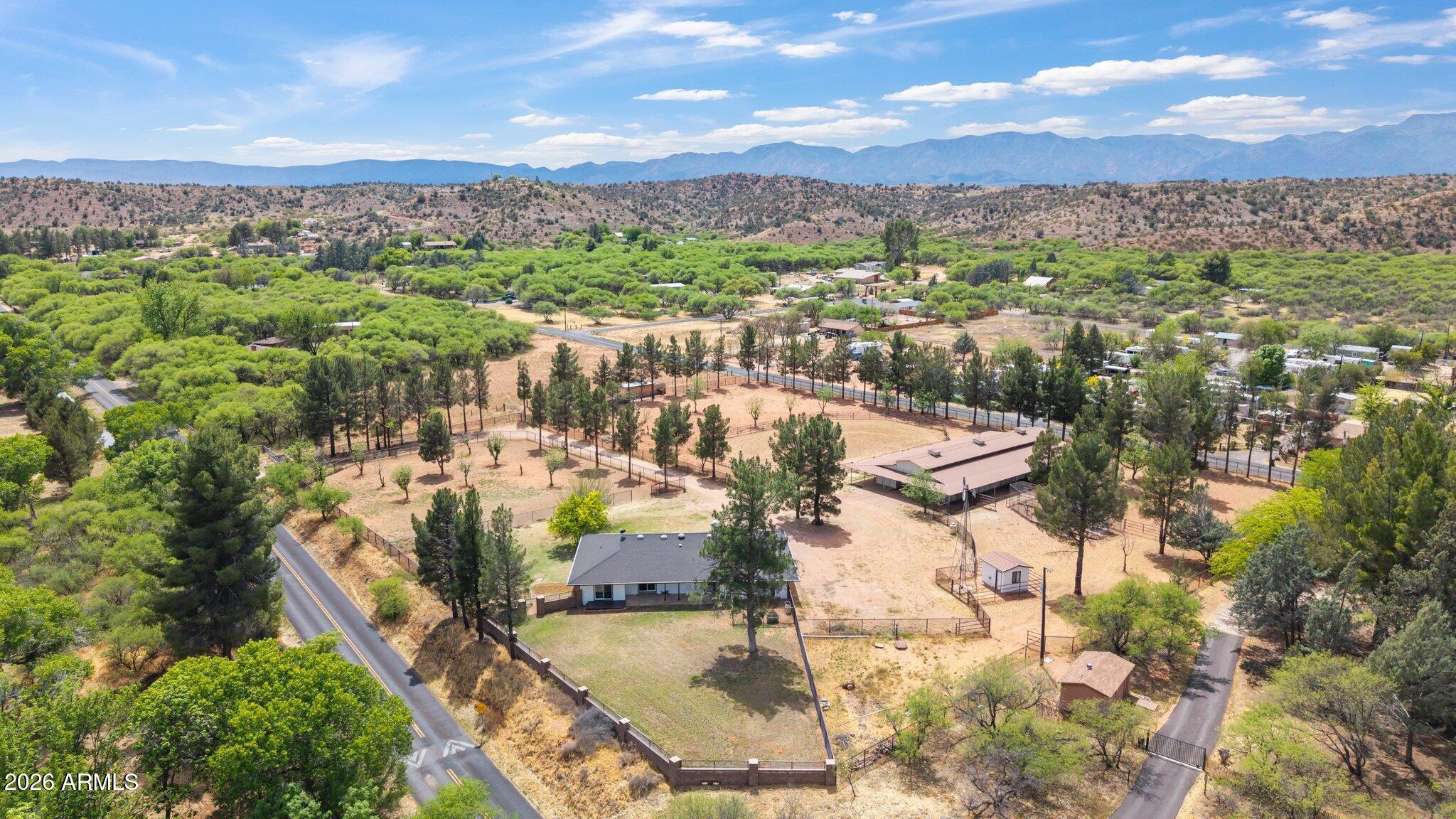 Fully renovated farmhouse offering the perfect blend of rustic charm & modern comfort, inside & out. The main residence spans 1,790 sq. ft. featuring 3 bedrooms, 2 full updated bathrooms, all thoughtfully designed for easy living.  Set on 3.56 acres, this exceptional equestrian property is ready for both hobbyists & serious horse enthusiasts. The barn currently includes 8 stalls w/ spacious broodmare stalls that can be reconfigured to accommodate up to 11 stalls & tack/feed rooms. Each stall features automatic water & convenient indoor/outdoor runs that open directly to lush pastures.  The grounds are equally impressive w/ wrought iron cross fencing throughout, 2 automatic entry gates, arena & multiple large turnout areas ideal for rotational pasture grazing.  Additional amenities include. Additional amenities include a charming chicken coop, a fully fenced backyard perfect for dogs.  Independence of lifestyle with a recently upgraded septic system and private well w/ clear water & ultra violet light systems.  Enjoy a peaceful, self-sufficient lifestyle surrounded by wide-open skies & natural beauty, while still being just minutes from shopping, dining, & entertainment to downtown Cottonwood & Sedona.  This is country living at its finest, where privacy, comfort, functionality & serenity come together in one remarkable property.