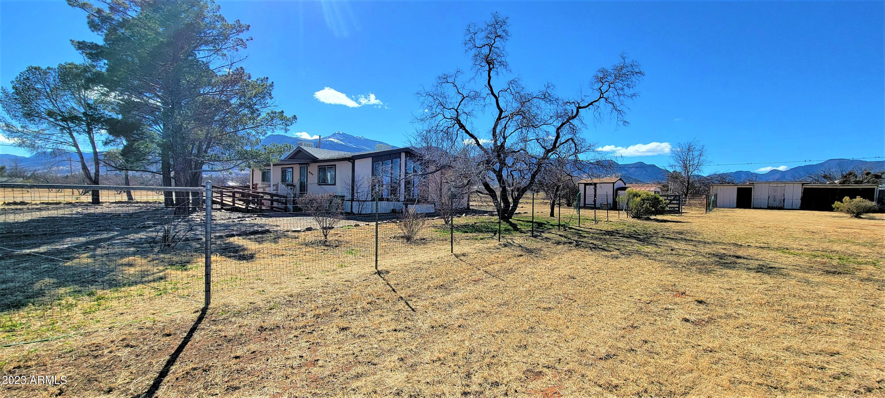 Here is a great opportunity for a reasonable priced home on 1 acre with some horse facilities. The property is fenced and cross fenced and has a loafing shed and tack room area. There is also a 2 car carport as well. The home has a great floor plan with an open living area and builtins in the dining room. The refridgerator. washer and dryer all stay with the home too. There is a wonderful Arizona room in the back with a separate storage area at one end. This home has 2 bedrooms and 2 baths. The master suite is very cute and has a large walk in closet. I know that you will love the wonderful mountain views too. Come and make this wonderful home yours! The home does need updating and some repairs. The price is reflective of this. The seller is unable to make any improvements or repairs.