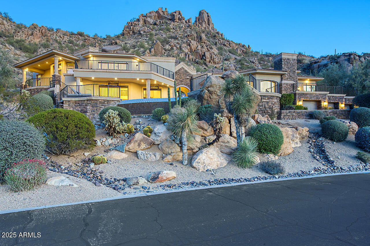 Exquisitely remodeled custom estate in North Scottsdale's exclusive guard gated Estancia is remarkable in every way.   Exceptional homesite perfectly designed to capture panoramic postcard worthy mountain, city and golf views while perfectly nestled hillside with Pinnacle Peak Mountain and Sonoran Desert as your backdrop.  Enjoy layered mountain range silhouettes overlooking the 6th, 7th and 8th holes of the renowned Estancia golf course.  Extraordinary outdoor living spaces with showstopping first impression - negative edge pool and spa, turf and paver lounge area, covered patio, generous hardscaped area for entertaining and lounging, and built in BBQ grill.  Seamless indoor-outdoor AZ living with spacious living areas with soaring ceilings boasting breathtaking panoramic views across