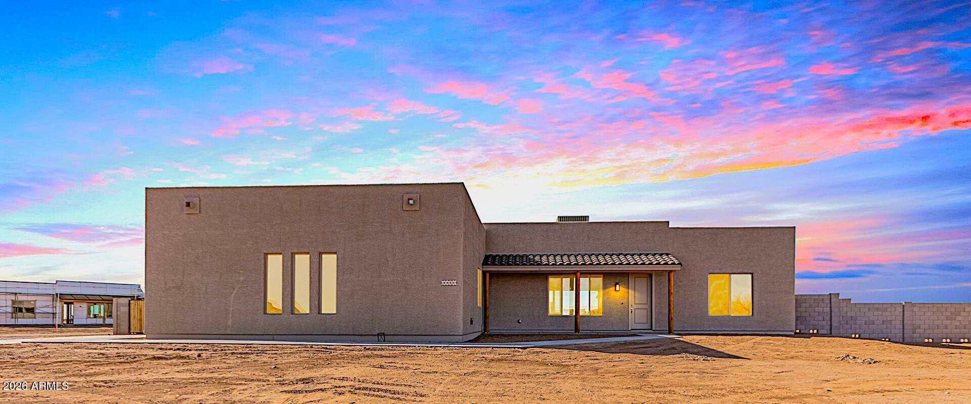 Enjoy peaceful living just outside the city. This beautiful home is situated on 1 acre fully enclosed with a block wall. ON A CORNER LOT 5 bedroom 2 bath  3-car garage  home w/ RV gate. NO HOA! 10' ceilings 8' doors, upgraded lighting, and a 12' sliding glass door to the patio. Additional upgrades include a large quartz center island, Soft-close cabinets, under-cabinet lighting, stainless steel appliances and hood, a tiled backsplash, and a walk-in pantry.  The primary bedroom and bathroom include a tiled and glass walk-in shower, 2 walk-in closets, double sinks, a private toilet room, and an exit to the outdoor patio. Pictures are of a different home same floorplan.