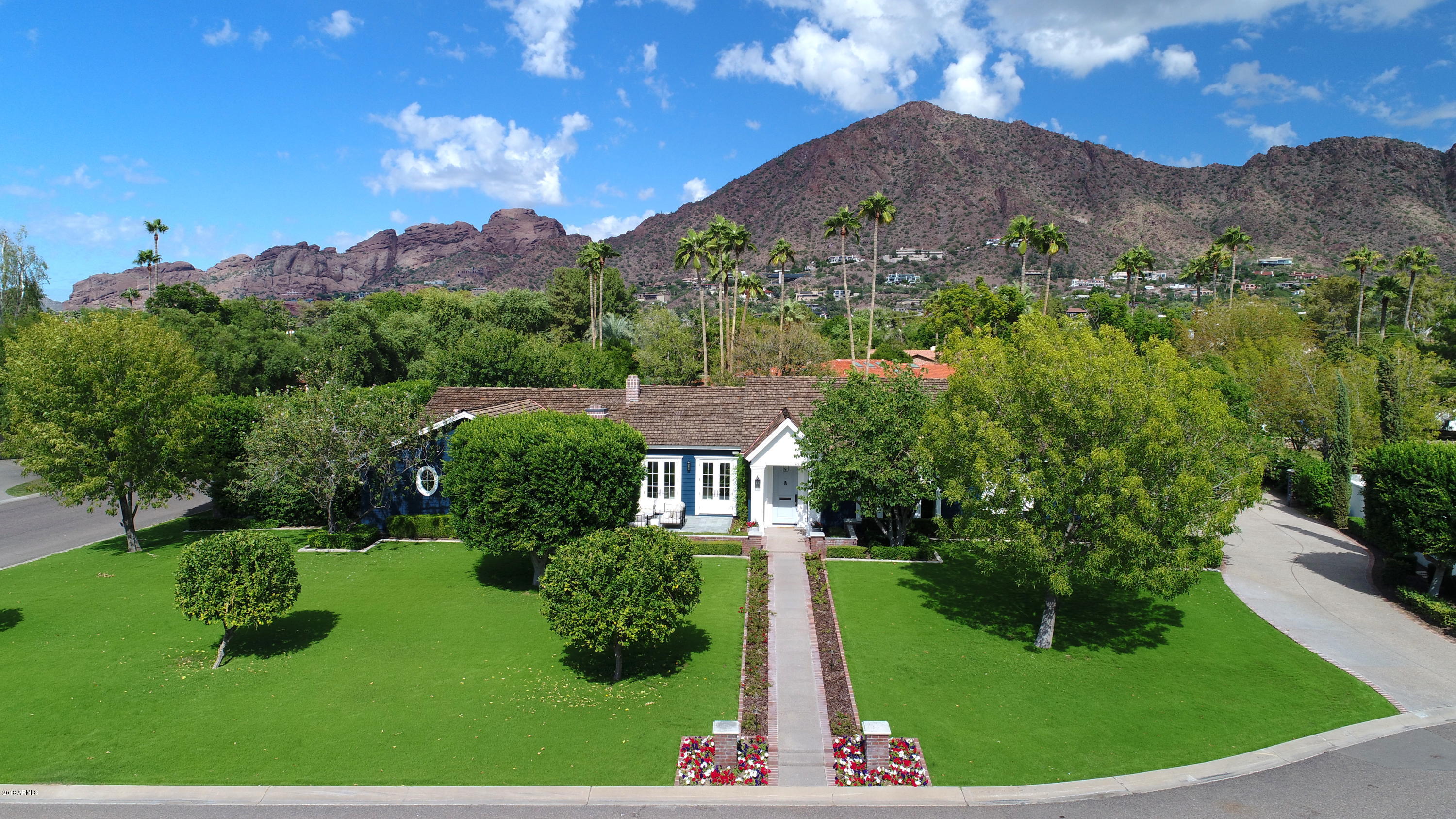 Arcadia warmth & charm is evident from the moment you pull up to the curb of this beautiful home. This 4 bedroom/5 bath home complete w/media room & library/den is understated in its outward appearance making it even more special as you enter through the front door. Built in 2008 on a large north/south lot, this home sits directly under Camelback Mountain with stunning unobstructed views, beautifully landscaped grounds and large brick and bluestone patios.  It was built to take advantage of our perfect AZ climate, flowing freely from inside to out, front to back, making entertaining in this home a wonderful experience. Constructed by its owners of the highest quality and classic in nature, this meticulously cared for home will stand the test of time. Some other details of the home include: 3/4" quarter sawn, rift cut white oak plank flooring throughout the home 
-Natural stone and marble flooring in each of the four en-suite bathrooms
-Hand-painted European style Christopher Peacock cabinetry in the kitchen and butler 's pantry
-A combination of honed marble countertops and soapstone throughout
-High end kitchen appliance package including a 6-burner gas Wolf range, Sub Zero glass front refrigerator, 150 bottle Sub Zero wine refrigerator, two Bosch dishwashers, and a Miele speed oven
-Top of the line Toto toilets and high end plumbing fixtures throughout
-Large Antique French crystal chandelier in the dining room
-Interior French door sets with beveled glass leading to the dining room
-High end lighting fixtures throughout
-Large Walk in closets in each of the bedrooms
-Extra large walk in master closet with built in cabinetry and a stackable washer/dryer
-Separate kids wing laundry room with full size LG Washer/Dryer
-Built in cabinetry in mud/hobby room
-Built in floor to ceiling book shelves in the office/library
-Outdoor brick fireplace in the cozy, front courtyard
-Pool, sport court and outdoor Kitchen Aid barbecue in the large, grassy back yard
-Fully mature and professionally maintained landscaping along with beautiful outdoor landscape lighting in the front and back yard
-Weathershield casement and double hung tilt windows
-Weathershield French doors throughout including bi-fold French doors opening to the rear yard
-Crown molding and 8" baseboards throughout
-Painted paneled wood in the den/media room and one powder room
-Beautiful Ralph Lauren burlap wallpapered master powder room 
-Rocky Mountain hardware throughout
-Decorative steel registers in all public spaces including the master bedroom
-(3) Trane 2 Stage high efficiency A/C units, serviced semi-annually
-(3) Rinnai tankless water heaters, serviced annually
-Nuovo whole house water softener system and R/O System
-Surround Sound speakers in all public spaces including outdoor patios and master bedroom
-Exterior of the home: HardiePlank Lap Siding & Azek Trim