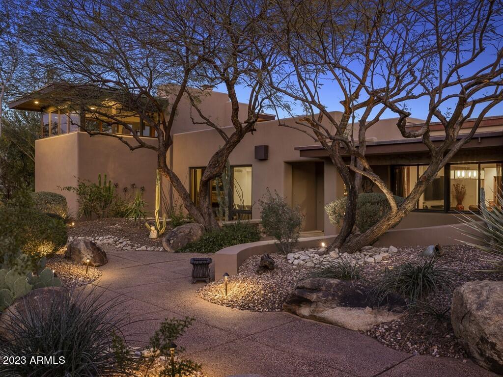 THIS EXTENSIVELY UPDATED HOME SITS ON A CUL-DE-SAC LOT WITH A PRIVATE BRIDGE DRIVEWAY ENTRY AND MAGNIFICENT VIEWS, RIGHT IN THE HEART OF MUMMY PARK NEIGHBORHOOD. 3 BEDROOMS WITH EN-SUITE BATHS AND 2 POWDER ROOMS IN THE MAIN HOUSE ALONG WITH A 1 BED/BATH GUEST HOUSE. JUST OFF THE ENTRANCE OF THIS HOME YOU WILL FIND A WATER FOUNTAIN AND A CUSTOM WOODEN FRONT DOOR WITH GLASS ACCENTS. THE INSIDE BOASTS WOOD FLOORING THROUGHOUT THE HOME AND TILE IN ALL THE BATHROOMS. THE LIVING ROOM FEATURES GLASS DOORS LEADING TO THE COVERED PATIO AND THE FORMAL DINING ROOM HAS A GAS FIREPLACE WITH STACKED STONE SURROUND THAT CREATES A GREAT DINING AMBIANCE. THE GOURMET KITCHEN FEATURES ALL TOP-OF-THE-LINE STAINLESS STEEL HESTAN APPLIANCES AND A 5-BURNER GAS STOVE WITH GRILL AS WELL AS A MICROWAVE DRAWER. AN OVERSIZED CENTER ISLAND ANCHORS THE SPACE WITH EAT-UP BAR SEATING, DESIGNER PENDANT LIGHTS AND OPENS TO THE FAMILY ROOM, CREATING A PERFECT SPACE FOR ENTERTAINING. JUST OFF THE KITCHEN YOU WILL FIND A BREAKFAST NOOK WITH A CONVENIENT BUILT-IN DRY BAR WITH A BEVERAGE FRIDGE. AT THE GARAGE ENTRY THERE IS A CONVENIENT ARCADIA NOOK AND A SEPARATE LAUNDRY ROOM WITH BUILT-IN CABINETS, A REFRIGERATOR, AND A UTILITY SINK. THERE IS ALSO AN ADDITIONAL BACK PANTRY FOR EXTRA STORAGE SPACE. THE MASTER SUITE OFFERS TONS OF WINDOWS WITH ELECTRONIC SHADES, A SEPARATE SITTING AREA, AND A PATIO DOOR TO ACCESS THE BACKYARD. THE LUXURIOUS SPA-LIKE MASTER BATH BOASTS FLOATING DUAL VANITIES, A SEPARATE MAKE-UP VANITY, WALK-IN SHOWER, AND A DESIGNER SOAKING TUB. A SPACIOUS WALK-IN CLOSET WITH CUSTOM BUILT-IN CABINETRY, SHOE RACKS AND DRAWERS COMPLETE THE FANTASTIC MASTER SUITE. A STUNNING WROUGHT IRON STAIRCASE WITH WOOD STEPS WITH DESIGNER TILE INSERTS WILL LEAD YOU TO THE UPSTAIRS BONUS ROOM OR AREA THAT FEATURES A SPACIOUS PRIVATE WALK-OUT BALCONY AREA TO ENJOY THE AMAZING MOUNTAIN AND CITY VIEWS! A SEPARATE GUEST CASITA OFF THE MAIN HOUSE OFFERS A KITCHENETTE, LIVING ROOM AND A SEPARATE BEDROOM AND BATH FOR YOUR GUESTS AND FAMILY TO ENJOY THEIR PRIVACY. THE COVERED PATIO AREA HAS A BUILT-IN BBQ, TRAVERTINE PAVERS AND LEADS YOU TO THE SPARKLING SALTWATER POOL THAT ALSO HAS TRAVERTINE SURROUND. JUST OFF THE SALTWATER POOL IS A LARGE EASY-CARE SYNTHETIC GRASSY AREA ALL SURROUNDED WITH BEAUTIFUL DESERT LANDSCAPING SURROUNDED BY GREAT VIEWS. TO COMPLETE THIS BACKYARD OASIS IS AN ABOVE GROUND BULLFROG A SERIES SPA WITH A SEPARATE SEATING AREA THAT MAKE THIS HOME AN ABSOLUTE ENTERTAINER'S PARADISE! LUCIOUS DESERT LANDSCAPING SURROUNDS THE HOME COMPLETELY FOR ULTIMATE PRIVACY. 3-CAR GARAGE WITH A WORKSHOP AND AN RV GATE.  YOU'LL LOVE HAVING THIS HOME AS YOUR VERY OWN PERSONAL RETREAT!