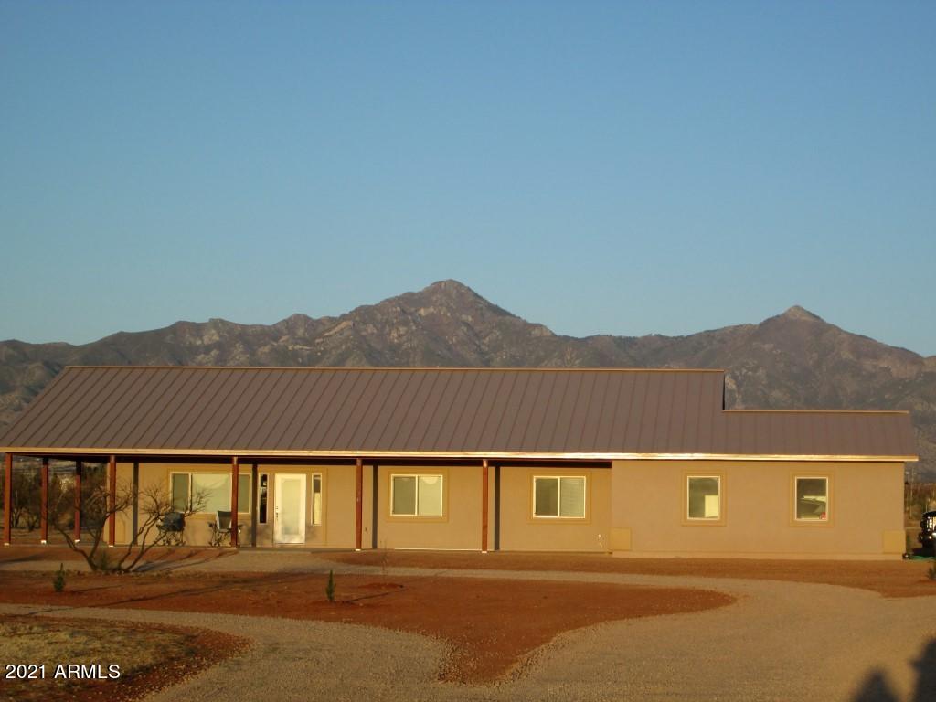 HUGE Price reduction! GORGEOUS CUSTOM NEW Home with ALL the Extra's and More! This spacious 3Bd/2Ba open floorplan has everything you would want in your forever home! Located on 4 acres with majestic mountain views it has a metal roof, gas fireplace. Nest thermostat, magnetic door stops, ceiling fans in every room and custom ceramic tile throughout. Two sets of French doors lead out to the 1400 sq ft WRAPAROUND covered patio where you can enjoy your morning brew and mountain views! The huge master suite boasts a beautiful & spacious bathroom with double sinks, granite counters & a fully tiled walk-in shower. The kitchen is a chef's delight with 
energy star SS appliances, upgraded gas range & hood, microwave. granite counter tops & more. This is a spectacular ''must see'' home!