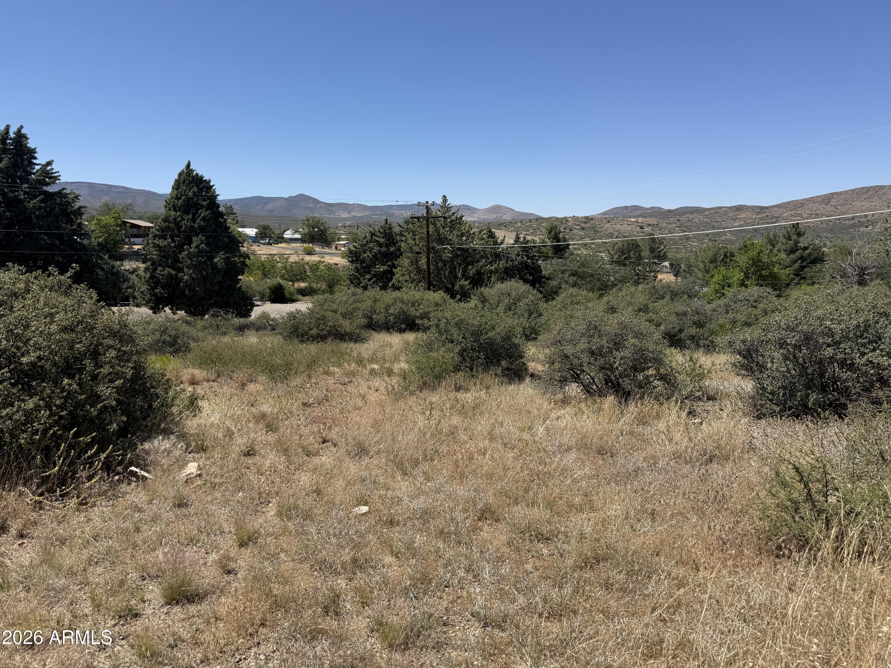 Slightly sloped, with terrific views, this lot in Mayer, AZ is zoned for manufactured or site built homes.  No HOA  Nice location, cooler elevation at 4,400 ft, and on a paved road.  Power is also at the road.  Easy to get to Hwy 69 and an easy commute to Prescott or Phoenix.  Affordable price!