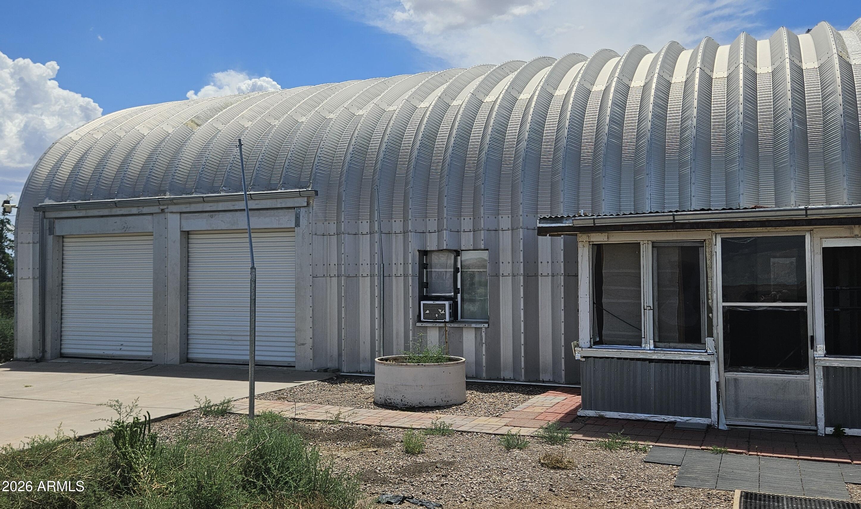 Are you thinking you would like something outside of the box? How about 2 nicely built Quonset Huts on 37.69 acres! The larger Quonset Hut is approximately 2,400 square feet exterior measurement with the interior home portion having 3 bedroom, 2 baths at approximately 1,871 with an open loft (could easily be converted to increase square footage and living space) and a 2 car garage. The smaller Quonset Hut is approximately 1,200 square feet exterior measurement with an approximately 250 square foot studio apartment with 1 bathroom and a 2 car garage. Enclosed chicken coop and run. Large garden area with a block wall around it. Front and rear enclosed patios on main home.RV plug in by second building. Each building has its own septic tank. All located in Valley Springs Estates with no HOA.