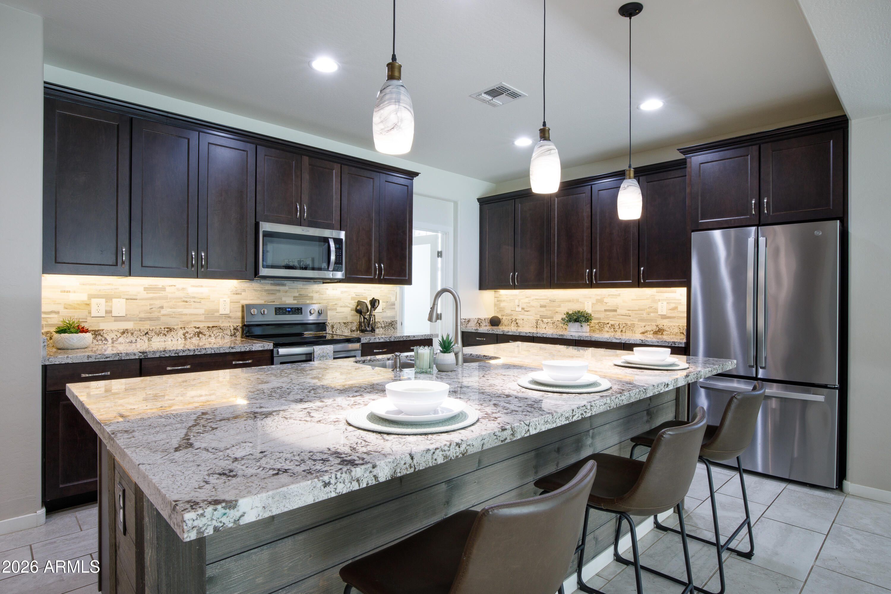 Enjoy this amazing location in gated Lehi Crossing, one of Mesa's most sought after communities with gorgeous parks, biking and walking trails, playgrounds and recreation. This 2018 built single-level home offers 3 bedrooms, 2 baths plus office or flex space. A bright open kitchen provides 42 inch maple cabinets, center island with bar seating and granite counters. Spacious great room includes a custom wall and room for formal dining. Primary bedroom includes newer laminate floors and attached bath with a soaking tub, double sinks and roomy closet.  Enjoy easy-maintenance living with 12x24 tile flooring, three car tandem garage, back yard turf and water treatment system. All of this plus quick access to Loop 202 for easy travel to Scottsdale, downtown Phoenix and Sky Harbor Airport.