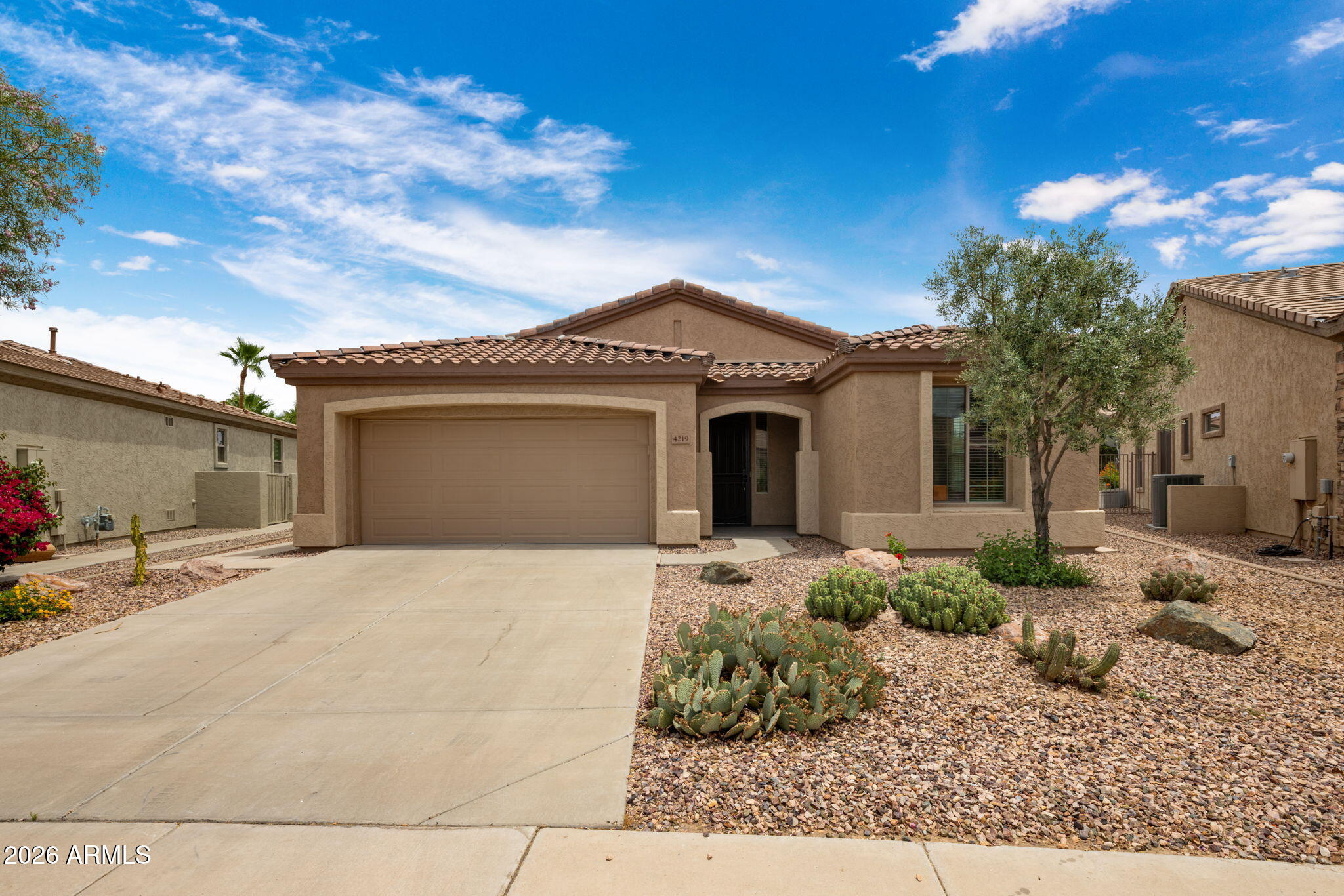 Experience resort-style living in the highly desirable Trilogy at Power Ranch, a premier 55+ community. Beautifully maintained home (ROOF 2025, A/C 2019) featuring an open-concept floor plan ideal for entertaining, with spacious living, dining, and kitchen areas highlighted by stunning granite countertops and stainless-steel appliances. The primary suite boasts a luxurious en suite bathroom with double sinks, generous closet space, and bay windows overlooking a serene yard. Enjoy Arizona's outdoor lifestyle in a lush backyard retreat, a large covered patio built-in BBQ and upgraded pavers with a fully fenced backyard. Bonus addition of 2 mini split A/C units for the garage to keep it cool all year round. Discover comfort, convenience, and an active adult lifestyle in this exceptional home! Trilogy at Power Ranch offers a vibrant community with a clubhouse, fitness classes, tennis, pickleball, sparkling pool, spa, walking paths, onsite restaurant/bar, and golf course, plus convenient access to shopping, dining, and medical services.