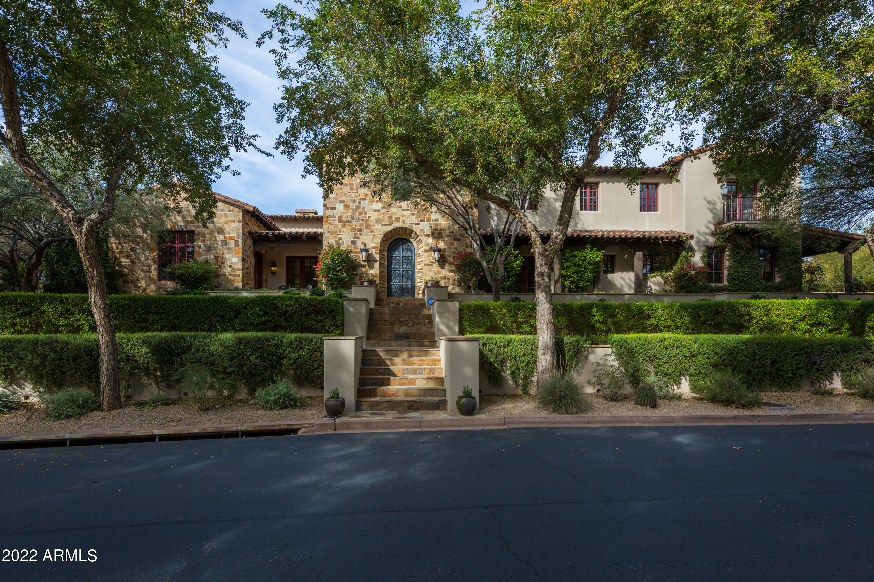 EXQUISITELY REMODELED & SITUATED ON THE BEST LOT BACKING TO THE REATA WASH AND LOCATED IN THE HIGHLY DESIRED NEIGHBORHOOD OF ARCADIA SILVERLEAF WITH BREATHTAKING MOUNTAIN & CITY LIGHT VIEWS! THIS STUNNER BOASTS FRENCH STYLE LUXURIOUS DETAILS & FEATURES FABULOUS LIGHTING THROUGHOUT, 5 ENSUITE BEDS/5.5 BATHS + BONUS ROOM, OPEN LIGHT & BRIGHT FLOORPLAN, FRENCH LIMESTONE & HARDWOOD FLOORING, CANTERA STONE FIREPLACES, GOURMET KITCHEN W/QUARTZ & MARBLE WATERFALL COUNTERS, CUSTOM CABINETRY, EGLOMISE MIRRORED GLASS BACKSPLASHES, SUB-ZERO & WOLF APPLIANCES, 2 NEW BOSCH DISHWASHERS, BUTLER PANTRY W/SUB-ZERO WINE FRIDGE & TWO REFRIGERATOR DRAWERS, HUGE LAUNDRY ROOM W/TONS OF CABINETS & ICE MAKER. FOR THE WINE ENTHUSIAST; ENJOY THE WINE TASTING ROOM W/A TEMPERATURE CONTROLLED WINE WALL THAT HOLD 864 BOTTLES AND AN ADDITIONAL WINE CELLAR TO STORE 212 BOTTLES!  THE PRIVATE MASTER RETREAT HAS A SITTING ROOM W/A COZY FIREPLACE, COFFEE/BEVERAGE CENTER, HIS & HER'S CLOSETS, HIS & HER'S WATER CLOSETS AND A HUGE TWO-SIDED ENTRY STEAM SHOWER. THE IMMACULATE OVERSIZED 3 CAR GARAGE HAS EPOXY FLOORING & STORAGE CABINETS. ENTERTAIN & ENJOY THE DREAMY AZ SUNSETS IN THE PRIVACY OF YOUR BACKYARD W/AN INVITING HEATED & COOLED SALT WATER POOL & SPA & SERENE WATER FEATURES, ELECTRIC SUN SHADES, OUTDOOR KITCHEN & A WOOD BURNING FIREPLACE. FOR A FULL LIST OF FEATURES & UPGRADES, SEE THE LIST IN THE DOCUMENTS TAB. THIS HOME IS TRULY SPECIAL & WILL APPEAL TO THE FUSSIEST BUYERS!  IDEALLY LOCATED TO SHOPPING, DINING & THE 101 FREEWAY.