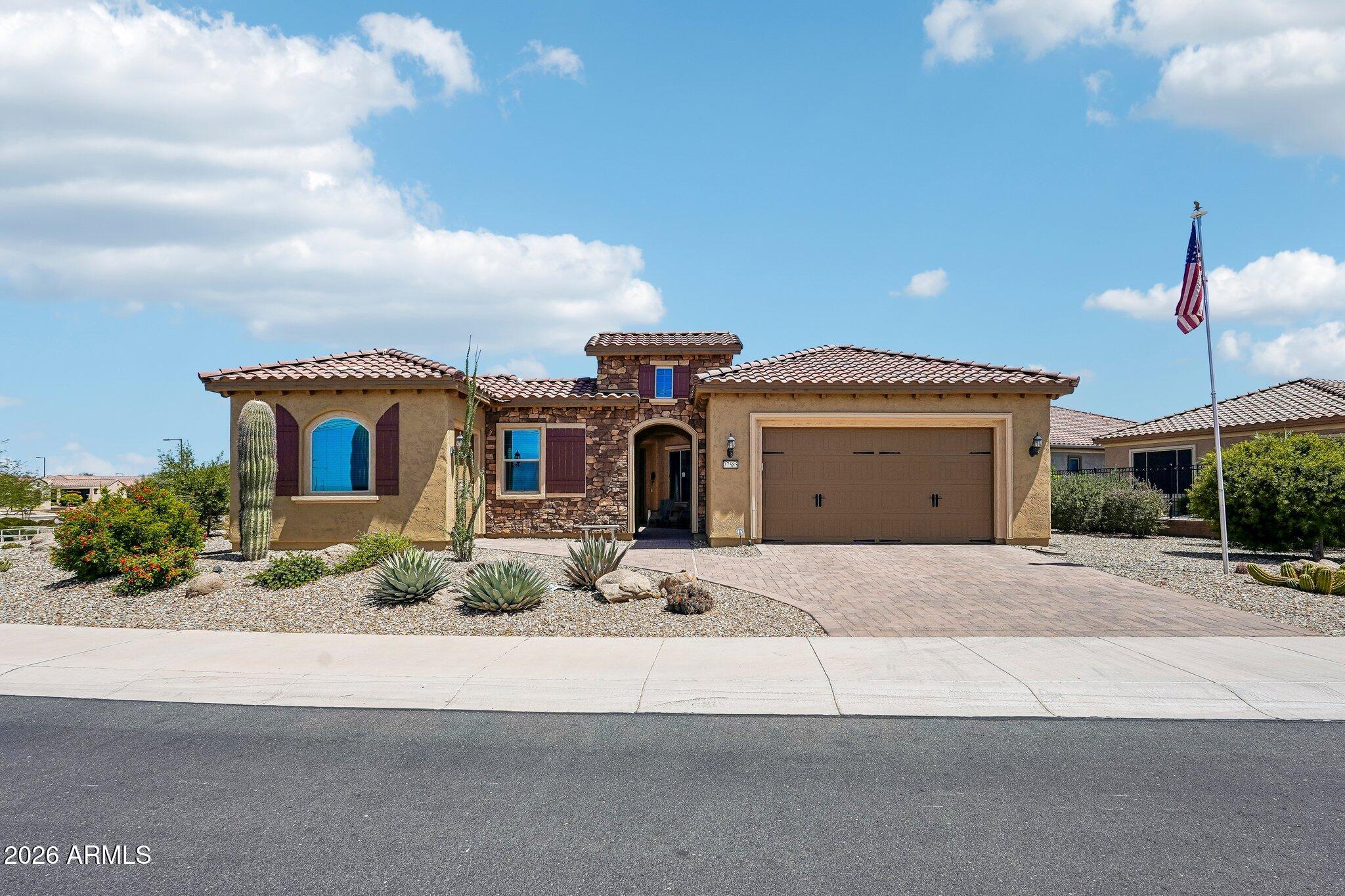Click the Virtual Tour link to view the 3D walkthrough. Assumable VA Loan at a low rate! 2.25% Situated on an oversized lot, this 2-bedroom, 2.5-bath Journey model offers over 2,500 sq ft with an open layout, private office/den, and separate guest wing with its own entrance. The kitchen features white cabinetry, granite countertops, gas cooktop, built-in ovens, stainless appliances, a walk-in pantry, and a large island. The primary suite includes dual sinks, a walk-in shower, spacious closet, and backyard access. Oversized sliding doors open to a covered patio with a misting system. Rolling sunscreen. Hot tub, a courtyard, extended garage space, and mountain sunset views. Discounted rate options and no lender fee future refinancing may be available for qualified buyers of this home.
