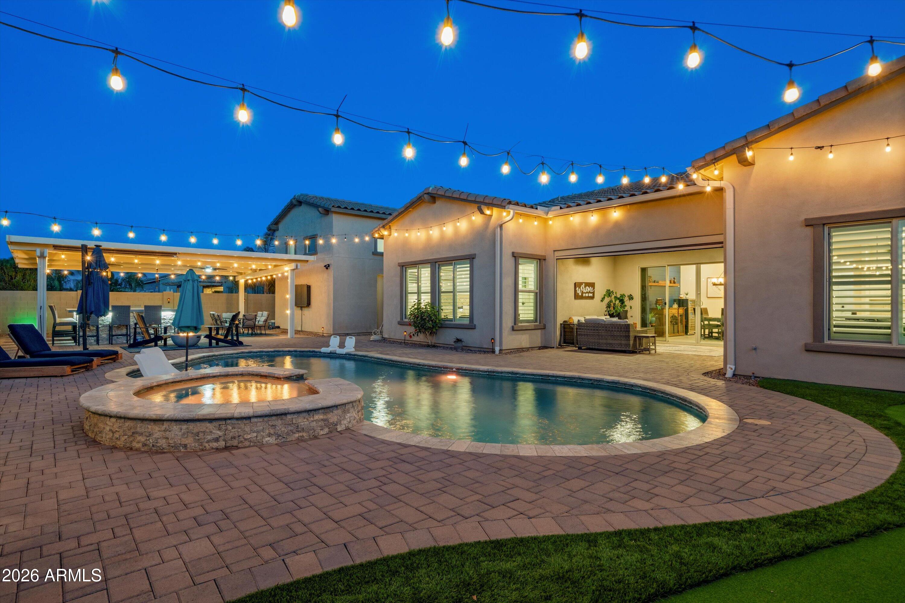Located in the gated community of Spur Cross, this home was built for the way people actually want to live and entertain.

From the moment you walk in, you'll notice the thoughtful upgrades; plantation shutters throughout, upgraded lighting, custom barn doors, ceiling fans in every bedroom, and a decorative metal security screen door that adds both style and function. Major updates are already done for you, including a new AC (2024), new dishwasher (2025), and a full water softener & purification system.

But where this home really stands out is outside.

The backyard is set up for hosting on a whole different level. A fully built-out outdoor kitchen features a flat top griddle, burners, warmer, refrigerator, ice maker, bar seating, and storage throughout. There's room for 15 + guests, plus a pool, spa, putting green, and dedicated dog run, all designed to actually be used, not just looked at.

And then there's the RV garage.

Fully air-conditioned and temperature controlled, this separate space comes complete with a golf simulator; making it the ultimate setup for hobbies, toys, or your own private escape.

Covered patio with lighting, dual fans, and an electric shade makes year-round outdoor living easy.

This isn't just upgraded, it's dialed in for how you want to live.
