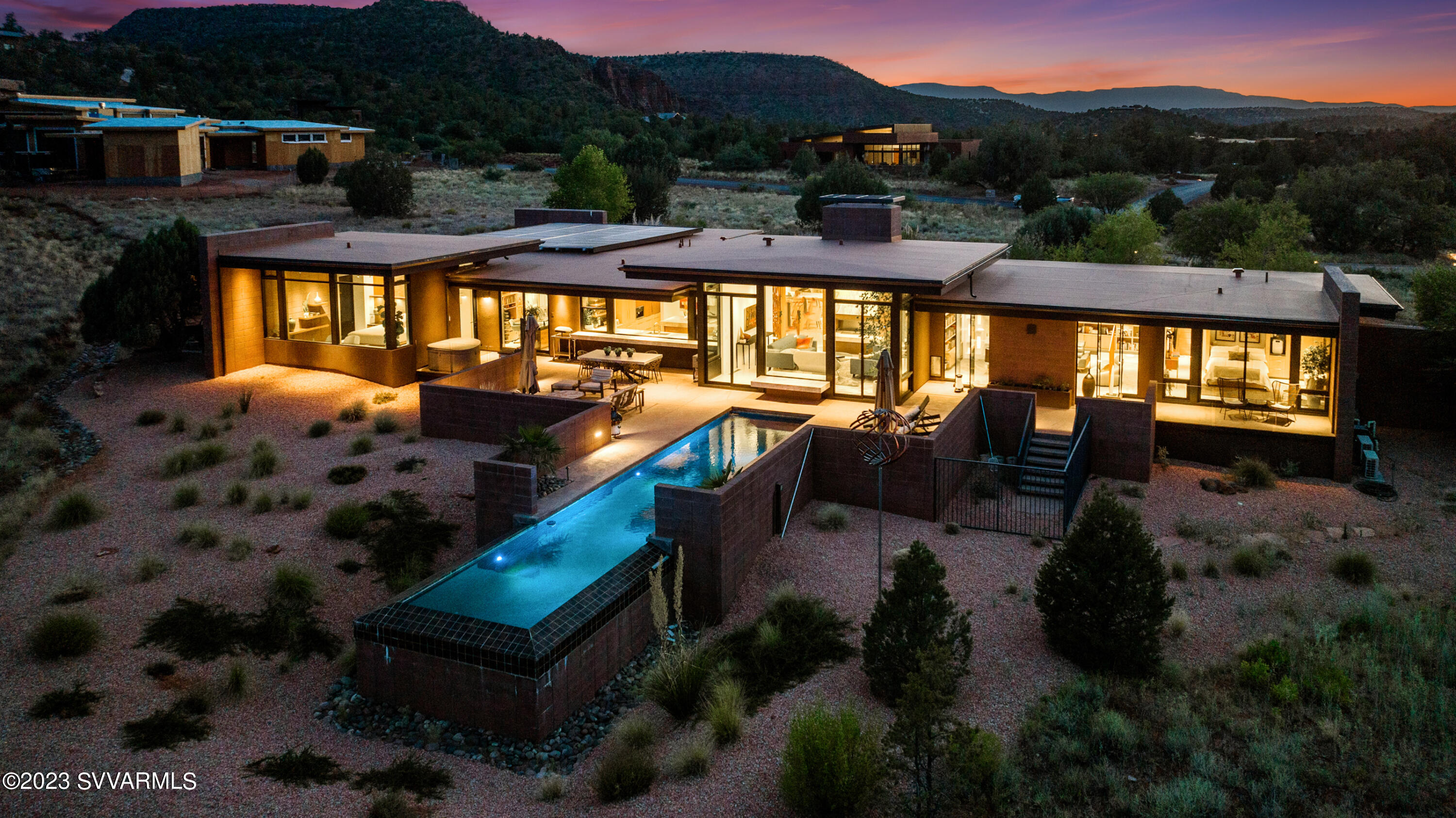 Breathtaking Mid Century Modern design that adds a touch of timeless elegance with a picturesque view of Cathedral Rock! The design of this newer home incorporates glass walls to maximize the unobstructed views and create a seamless connection with the surrounding natural beauty including bordering Red Rock State Park. Created by locally renown Design Group and built to precision by Randy Toogood, this home has a spacious and open layout that allows for a smooth flow between different areas. The design elements are carefully chosen to be visually pleasing and functional, providing both aesthetic appeal and practicality. The kitchen features high-end Miele and Wolf appliances, and numerous built-ins offering a gourmet cooking experience. This adds a luxurious touch to the overall feel and enhances the functionality of the space. In addition, this home was built with green technology and sustainability in mind, including passive solar design, high efficiency HVAC, low maintenance exterior and interior, ethanol fireplace, whole house photovoltaic solar system, electric vehicle charging, solar heated lap pool, smart home integration, ultra-high speed fiber optic internet and more... The current owner also added a lovely media room/den with amazing built-ins to match the original design. To enhance the natural setting, a modern berm is incorporated into the design. This feature adds visual interest and complements the overall aesthetic pleasure and privacy of this home. You will be pleasantly surprised at the unobstructed views and modern amenities along with a luxurious and comfortable living experience, all without having to endure the arduous process of trying to design and build it on your own.... Plenty of room to add another bedroom/guest casita as well!
