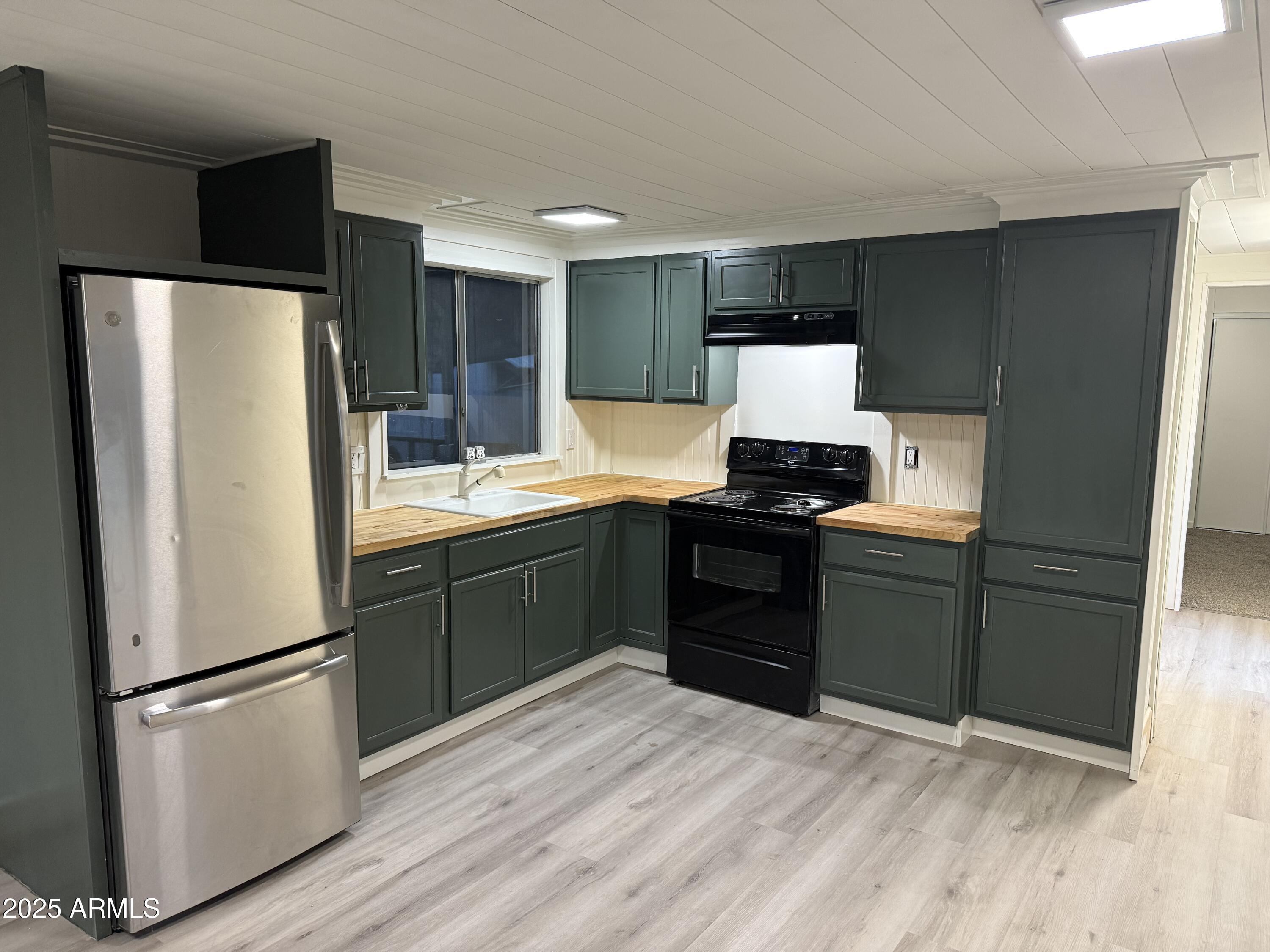 2000 down and we will carry the balance. Beautifully remodeled 1980 manufactured home in a quiet 55+ community on a leased lot. This move-in-ready home features a fully updated kitchen with new cabinets, butcher-block counters, fresh paint, and beadboard accents. New luxury vinyl flooring in the kitchen, utility room, and bath, plus new carpet in the living area and bedroom. Spacious layout with large windows, updated lighting, and clean, modern finishes. New HVAC system and tankless water heater provide efficiency and comfort. A great opportunity for low-maintenance living in a welcoming community. All electric!