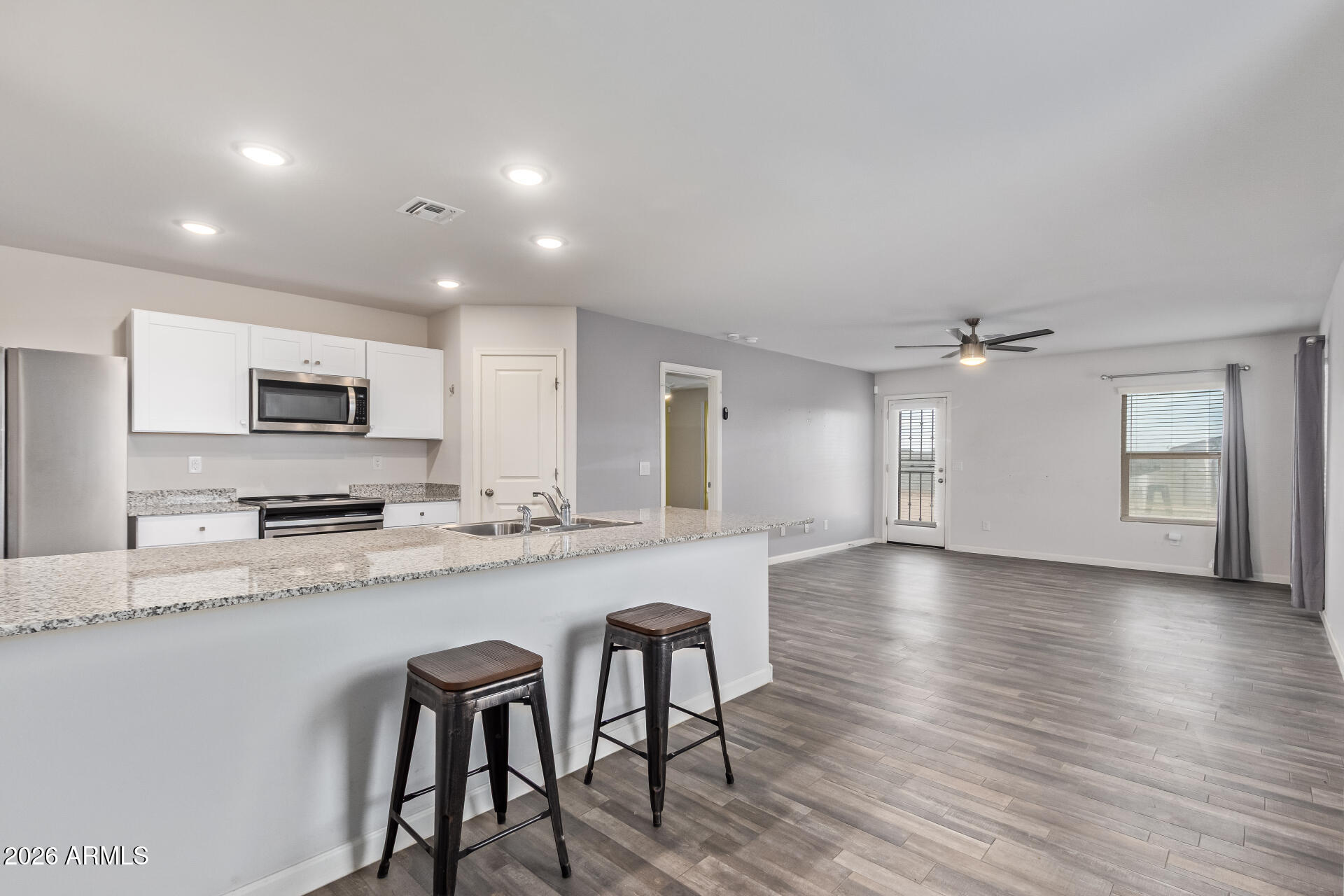 Don't miss your chance to own a home in the Toltec Arizona Valley Community with massive, spacious backyard! The sought-after 1517 Plan features a spacious open great room that flows seamlessly into a beautifully designed kitchen with gorgeous cabinetry, granite countertops, and stainless-steel appliances--including range, microwave, and dishwasher.

Unwind in the private primary suite, complete with a dual-sink vanity and walk-in closet. This home also includes a 2-car garage, offering both style and convenience. Modern living at its finest--this one won't last!