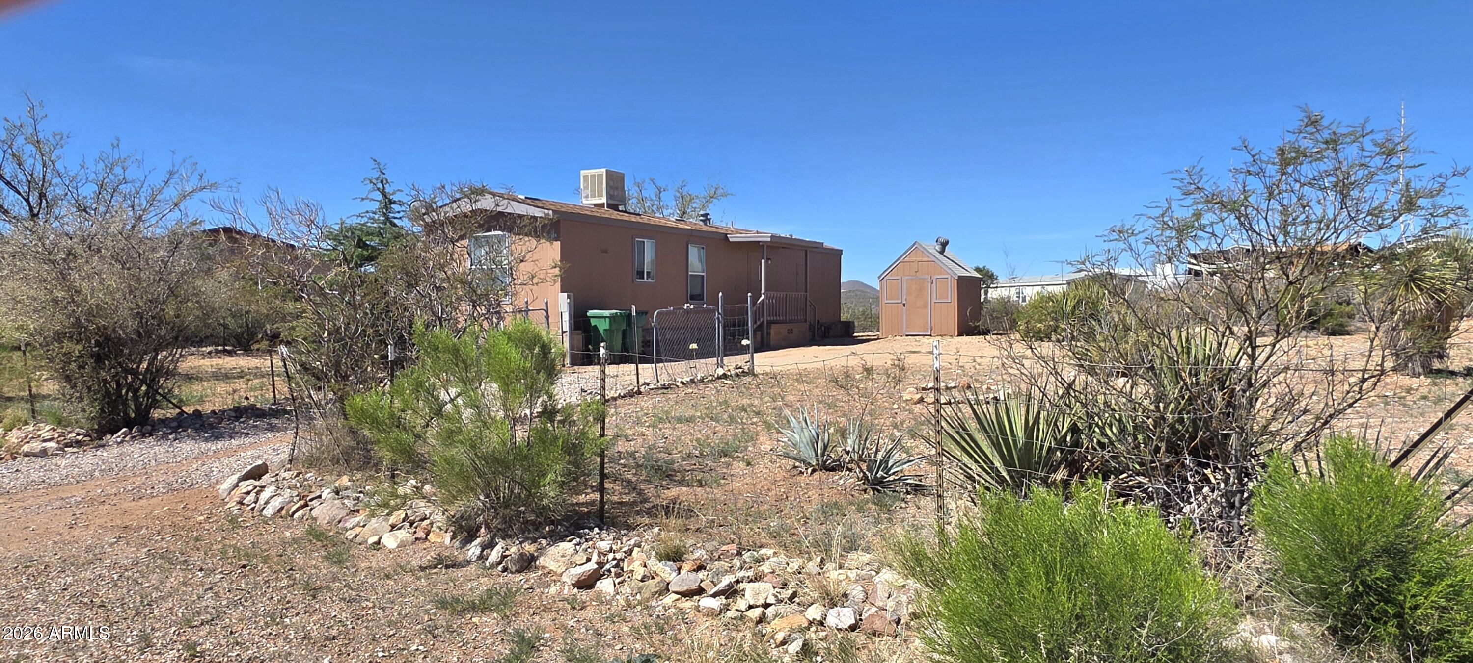 Two bedroom, one bathroom home in a quiet residential neighborhood. The yard is fenced and there is an outbuilding for storage. There is a 5.75 X 23 foot unheated bonus room. Just minutes from the heart of Tombstone.