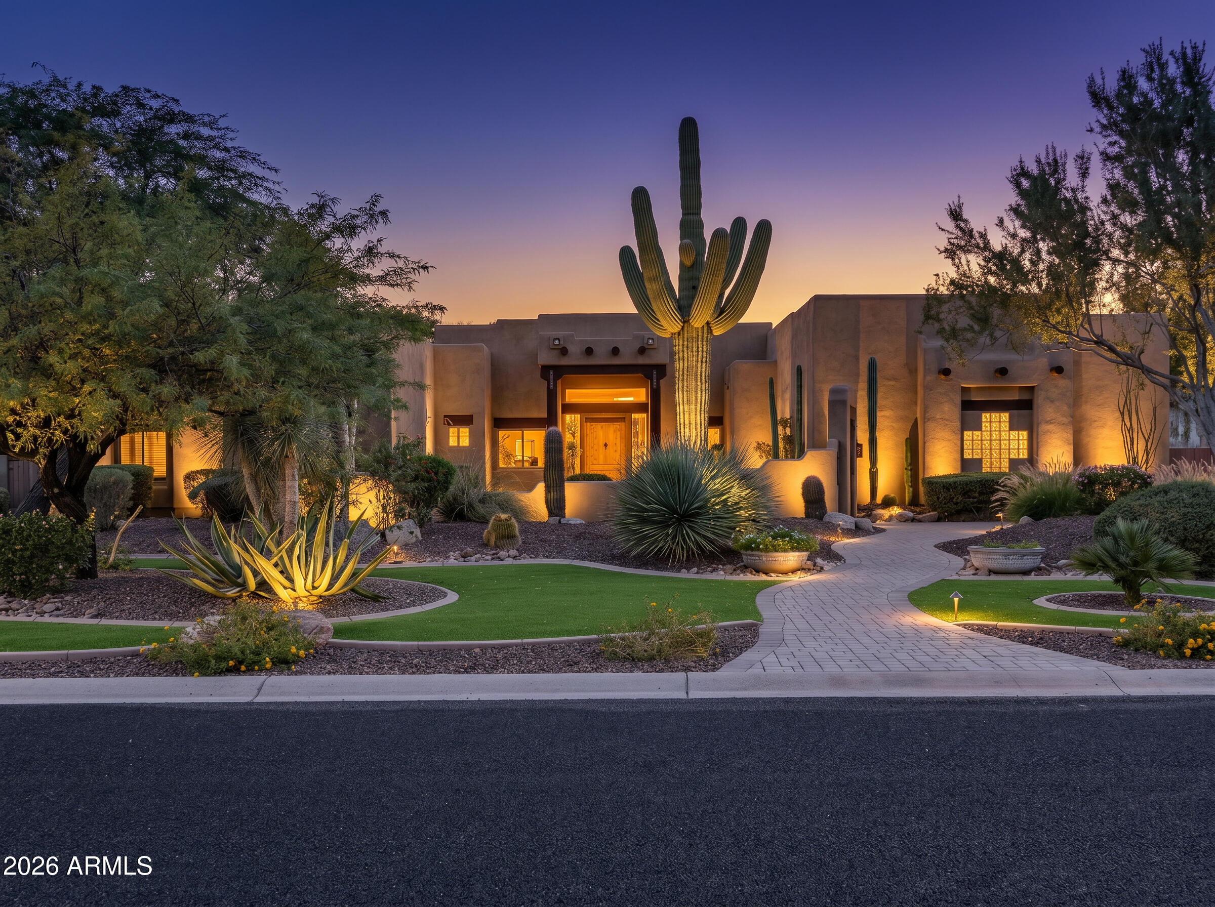 Experience luxury Arizona living in this stunning custom Territorial-style estate nestled on a sprawling, beautifully landscaped just under 1-acre lot. This exceptional property offers 4 bedrooms, 4 bathrooms, a private office, and an incredible detached RV garage designed for car enthusiasts, RV owners, and toy storage alike. A gated courtyard entry welcomes you with a charming fountain and manicured landscaping, setting the tone for the elegance found throughout the home. Inside, you'll find warm wood-beamed ceilings, separate living and family rooms, and exquisite custom finishes at every turn. The inviting family room showcases a dramatic stone fireplace, while the luxurious primary retreat features its own fireplace and private backyard exit. The gourmet chef's kitchen is thoughtfully designed with stainless steel appliances, double ovens, granite countertops, an oversized island, gorgeous custom cabinetry, reverse osmosis system, soft water system, and recirculating hot water for added convenience.

Step outside to your own private resort-style oasis. The backyard is beautifully designed with extensive stone paver walkways, pool and spa complete with waterfall and rock slide, covered poolside patio bar, an in-ground trampoline for added fun, and a hidden sunken conversation area with stone seating and fire pit tucked behind the waterfall -- truly an entertainer's dream.

Car enthusiasts will appreciate not only the massive 70 ft long detached RV garage, but also the main home's temperature-controlled 3-car garage with its own dedicated A/C system. The detached RV garage features extended-height ceilings, 250-amp service, an electronic rolling door with keypad access, A/C and evaporative cooling, private half bath, and additional storage room. Extensive front and side concrete parking areas provide even more room for vehicles, trailers, toys, or equipment.

The estate is further enhanced by a substantial FULLY OWNED 30kW Tesla solar system, delivering impressive energy production rarely found at this scale in residential properties.

This one-of-a-kind custom estate combines luxury, functionality, and unmatched garage/storage capabilities -- all on an incredible just under 1-acre lot with the upgrades and amenities you would expect in a premier custom home.