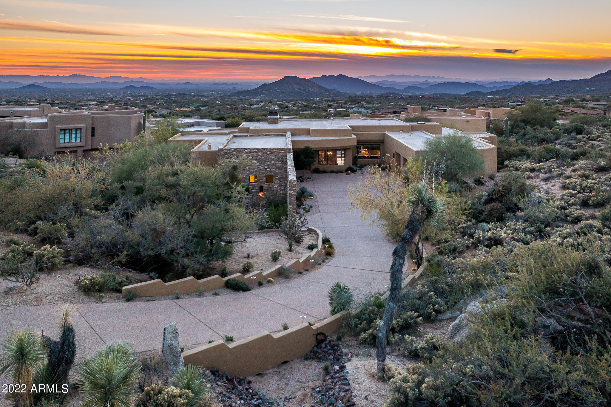 Wow is what you will say EVERY day & night  when you look at the panoramic mountain, city light, and sunset views from every major room in the house & outside patio. You will love entertaining in the open concept floor plan where everyone feels included w/multiple dining & sitting areas. Spacious master bedroom w/ sitting area & access to the backyard. Relax in the master bath w/large soaking tub. Dual side custom closet is located next to the laundry room. For those who like to tinker the third garage is climate-controlled w/large work room. The backyard features big views, an upper patio fire feature, & heated pool & spa w/ pebble-tec finish. The Fisher custom home takes advantage of the outstanding location in Apache Peak at the prestigious golf & lifestyle community of Desert Mountain!