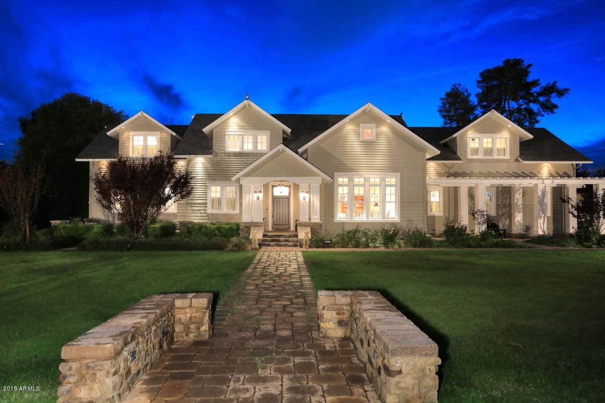 This exceptionally built and stunning Phoenix Country Club residence is located on a premier golf course lot with impeccable grounds. Features include an outstanding Kitchen plus a stainless prep kitchen, Wolf ranges, a walk-in refrigerator, granite surfaces, tongue & groove ceilings, solid core doors, distinctive millwork, walnut floors, lovely Powder room, Formal dining, a beautiful Master suite, folding glass wall of doors in Family room to backyard and independent room thermostats. 2nd floor has 4 BR's, great baths, a Library, Play Room and a terrific deck. The incredible basement offers a theater, 2 BR's, 2 BA's, office, stainless steel wet bar, curved glass wine refrigerator, billiard room and lounge. The exterior spaces offer a sparkling pool, covered patios, fire pit and fireplace.