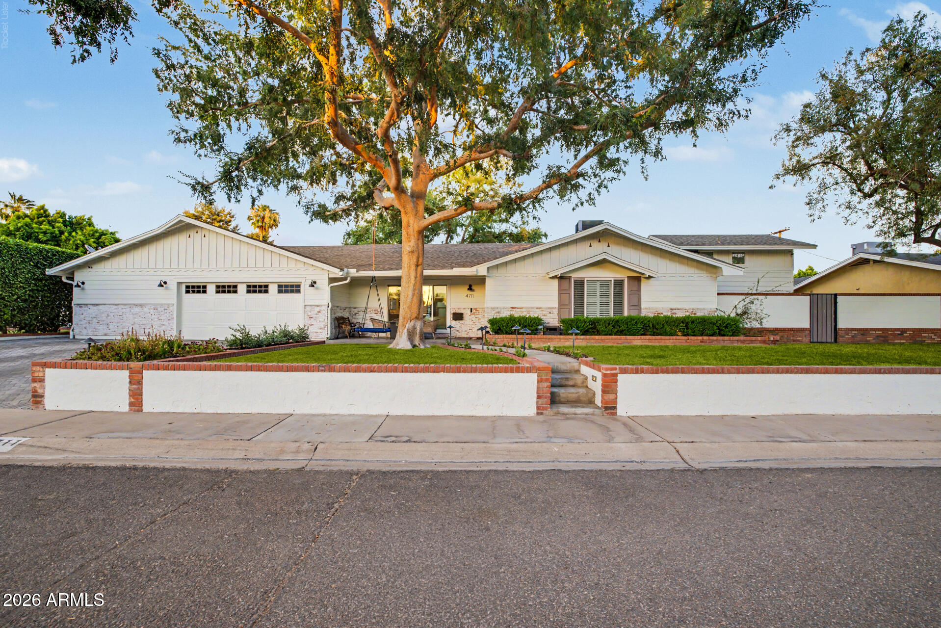 Nestled on a generous lot in the heart of Arcadia, this quintessential tree-lined ranch home seamlessly blends timeless charm with thoughtful modern updates. Extensively remodeled in 2018 and enhanced again in 2023, the home showcases a stunning new primary suite, beautifully redesigned kitchen, updated plumbing, and countless improvements throughout.
Offering 2,804 square feet of living space, the home features 4 bedrooms and 3.5 bathrooms with an ideal floor plan designed for both everyday living and entertaining. The spacious living room flows effortlessly into the dining area and chef's kitchen, creating a bright and inviting central gathering space. A separate den with its own bathroom provides exceptional flexibility as a guest retreat, office, media room, or playroom. The thoughtfully designed kitchen serves as the heart of the home, while a convenient wall-mounted filtered water dispenser makes it easy to fill up on your way to the garage or out for the day. The private primary suite is a true retreat, complete with a generous spa-like bathroom and an oversized walk-in closet.
Tasteful farmhouse-inspired finishes, warm white oak tile flooring, and abundant natural light enhance the home's inviting character. Step outside to experience the best of Arizona living, where a newly constructed pool and expansive covered patio create the perfect setting for outdoor dining, entertaining, and relaxing year-round. The large lot provides ample space to enjoy the outdoors while maintaining privacy and tranquility.
Adding to the home's versatility is a detached 205-square-foot multifunction guest casita, ideal for guests, a home office, fitness studio, or creative workspace.
A rare opportunity to own a beautifully updated Arcadia ranch home that perfectly balances style, functionality, and the indoor-outdoor lifestyle that makes the neighborhood so sought after.