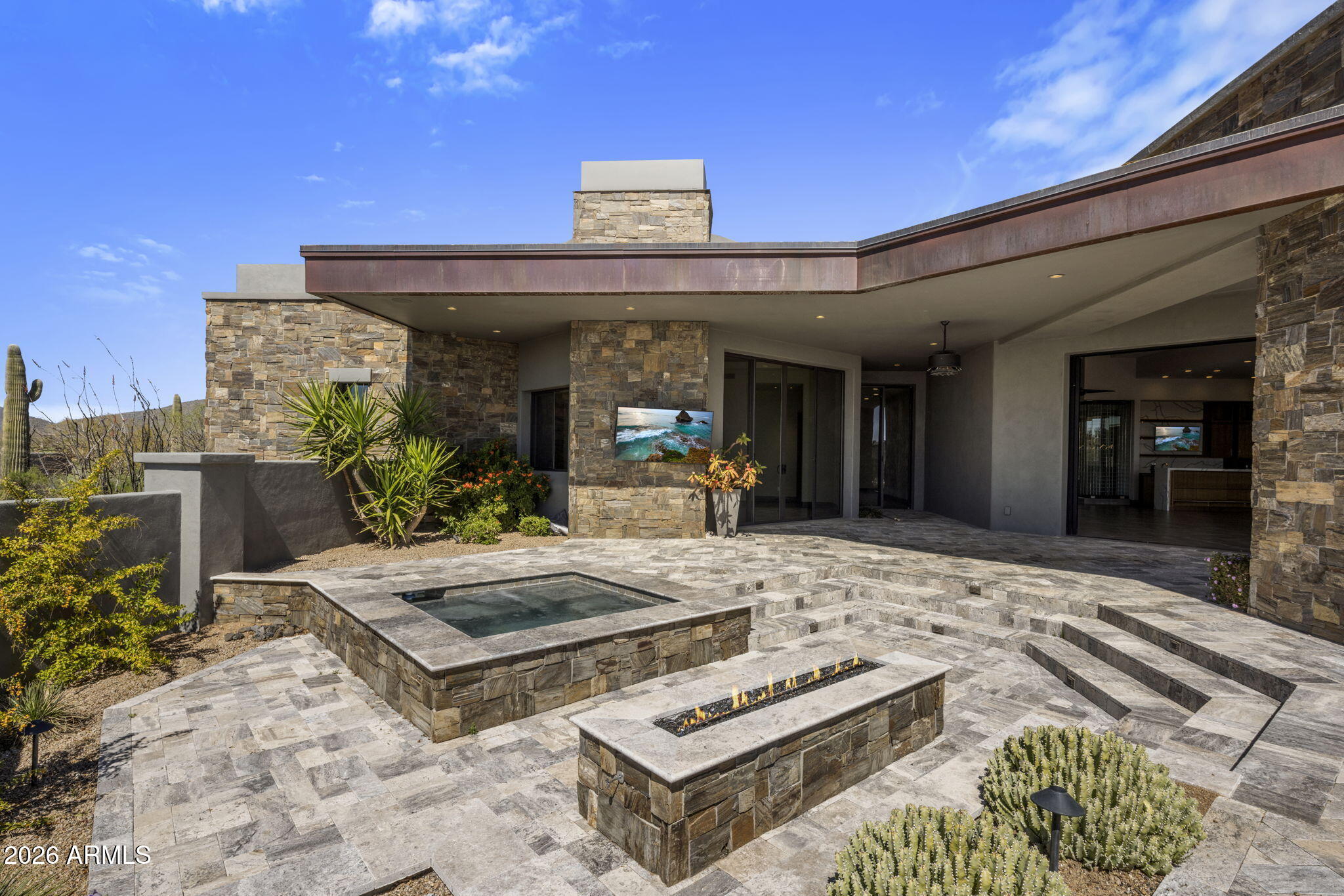 Just Reduced!!FULL GOLF MEMBERSHIP AVAILABLE. This modern Desert Mountain home in the Village of Painted Sky offers effortless single-level indoor-outdoor living, a spacious great room, and a well-executed split floor plan. Designed with elegance and simplicity, the residence enjoys privacy and sweeping views of the Apache Golf Course, sunsets, city lights, and surrounding mountains. Southwest patio exposure enhances natural light and outdoor enjoyment. The primary suite and office are located on one side of the home, with three en-suite guest bedrooms and a flexible bonus room on the other--perfect for a gym, media room, or additional living space. Finishes include tile flooring throughout, quartz countertops with waterfall edges and full-height backsplashes, and rift-cut walnut cabinetry