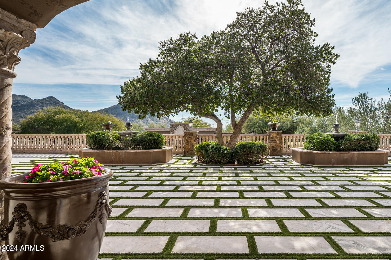 PRICE REDUCED $1M!!! Enter a long private drive to this 7 ACRE +/- compound in exclusive Gated Canyon Heights. Situated on a flat parcel w/spectacular Mountain + City Light views, the 20,088 sf, 9 bedrm compound features 2 HOMES w /2 swimming pools, one an OLYMPIC SIZED DIVING POOL w/high + low diving boards, a tennis court, racquetball court, wellness center, putting green, gym and large grass areas. The main house has 6 ensuite bedrms w/spacious living areas, game rm, den, bar, wine rm + movie theater. The separate guest house can function as 2 private apartments on separate floors each w/private kitchens, living areas & patios. The grounds have multiple patios, fireplaces, fountains, walking paths + childrens play areas.