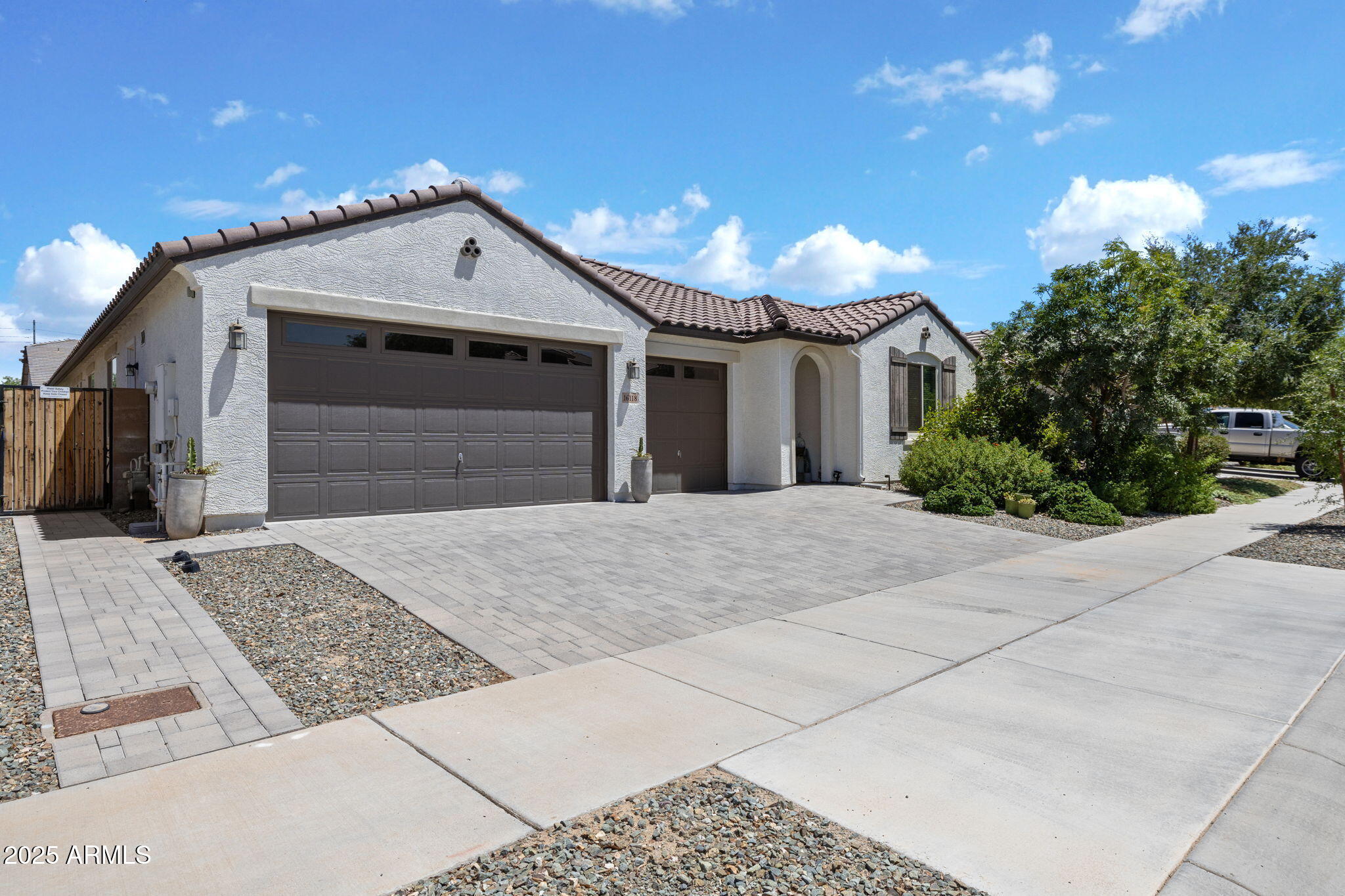 This stunning ONE OF A KIND - 4 Bed/3.5 Bath/3 car garage home WITH A POOL in the heart of Surprise AZ is for Sale!  There is so much to say about this amazing, versatile home!  Be sure to ask for the supplements & info regarding assuming current interest rate!  This home features a split floor plan perfect for all!  On one end, you will find a Jack & Jill Suite featuring double sinks in the bathroom.  On the other end, you will find an ''ALMOST'' next-gen suite, featuring living area w/kitchenette - private bedroom & bathroom.  In the center of the home, you will find a large Den or Flex space with beautiful built-in cabinetry.  In the heart of the home, you will find a SPACIOUS Living - Chef's Kitchen & Dining area ideal for grand entertaining or intimate gatherings. READ MORE HERE... LOOK at that Chef's Kitchen!!  Upgraded cabinets, appliances, countertops, lighting, wall oven and microwave, FIVE BURNER GAS stove, Walk-in Pantry, and the list goes on.  The Owner's Retreat is located at the back of the home offering tranquility with private bath featuring a walk-in rain shower.  The backyard Oasis w/extended patio & covered awning will not disappoint!!  Play or relax in the pool, cookouts on the built-in BBQ, marshmallows and laughter around the gas firepit - memories are to be made here!  The 3-car garage with built-in cabinets provides for ample storage space.  You will see upgraded Pottery Barn light fixtures, extra can lighting, 8 ft interior doors, central vacuum, upgraded tile and laminate flooring, accent walls and surround sound!  This home is conveniently located near Loop 303 and Village at Prasada offering an array of shopping, dining and entertainment- within minutes to the new Desert Diamond Casino, Wildlife World Zoo and White Tank Mountains and walking distance to the Middle School!  This just screams ....Welcome HOME!!