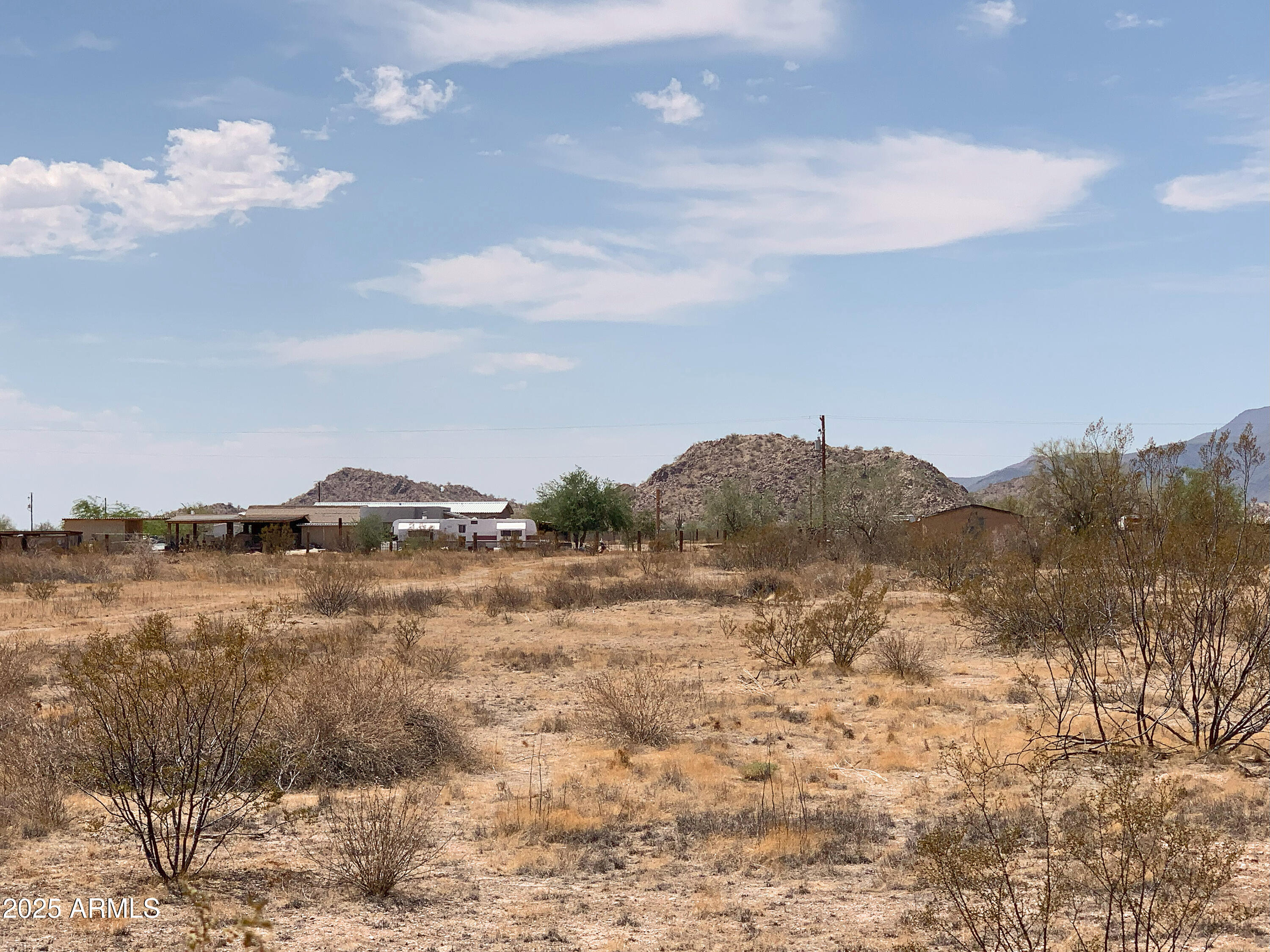Get ready to state that Hidden Valley Estates in Maricopa, Arizona, is your home! Lot 3 of FIVE incredible parcels on paved Whirly Bird Road is waiting for you! This 1.26-acre equestrian lot features stunning mountain views and the exciting option of seller financing! Join the Maricopa Mountain Water Co. for hauled water—ask your agent for details! Zoned GR (General Rural) with a 1.25-acre minimum, this lot cannot be split but offers wide-open spaces! Enjoy fresh desert air, beautiful native plants, paved roads, and peaceful vibes, all while being close to amenities. Don't wait—make Maricopa your home and start living the country life you love! *Note: 2024 taxes prorated from original parcel; MLD available in documents & photos tab.
