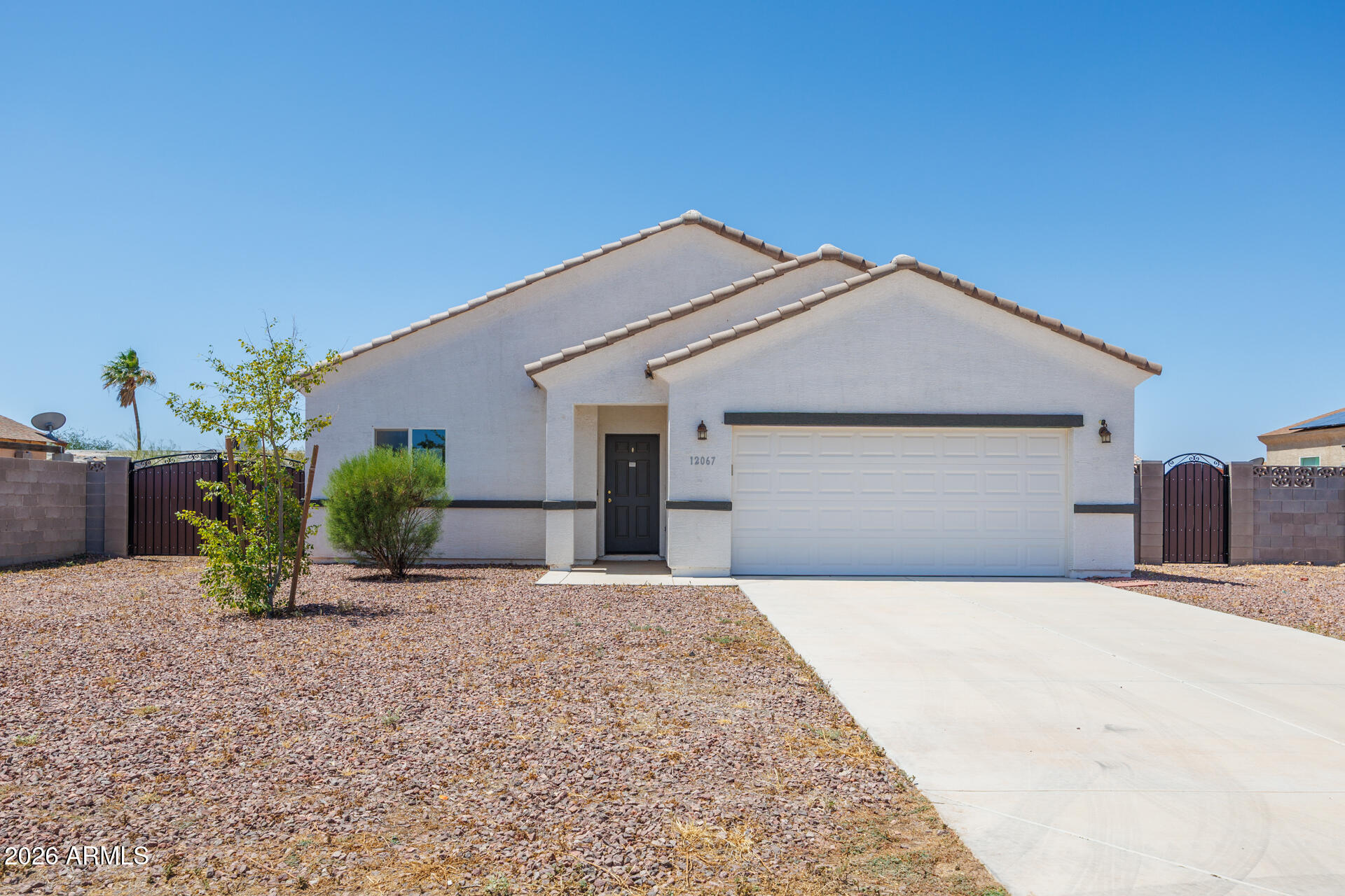 Built in 2021, this newer HUD home features 3 bedrooms, 2 bathrooms, and modern design elements throughout. The open kitchen has WHITE cabinets with hardware and granite looking counter tops. Exterior highlights include a durable TILE ROOF, BLOCK fence with two gates, a side gate and  RV gate. Out back enjoy a COVERED patio creating additional outdoor living space and rock backyard ready for your additional touches. The functional floor plan offers comfortable everyday living with newer construction appeal. Great opportunity to own in fast growing Pinal County with easy access to Phoenix and Tucson.