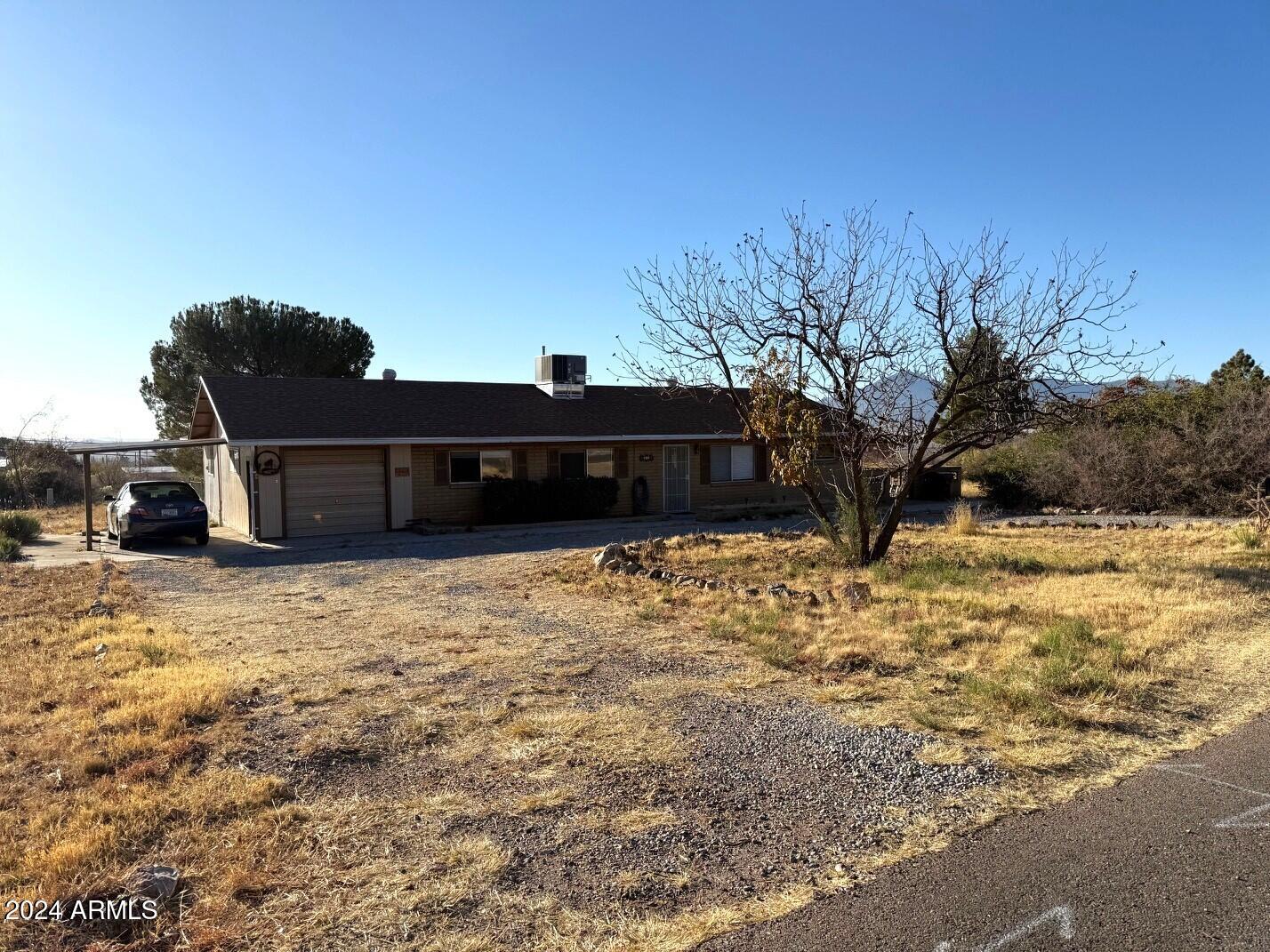 You will not want to miss this really cute home! Located on 1.5 acres there is plenty of room to stretch out. There is a fenced back yard area with a ramada and storage area as well as a covered patio on the west side. There are RV hookups on the east side of the property outside the fenced area. Step inside and you will find a nice living room area and breakfast nook off of the kitchen. There are newer appliances as well as newer vinyl plank flooring in the living areas. The master suite is lovely and includes an updated master bath with walk in shower. There is a good sized AZ room that includes a ping pong table. The laundry room is located off of this room.  Behind the garage there is a room that also has a 1/2 bath. This is not inc the sq footage.