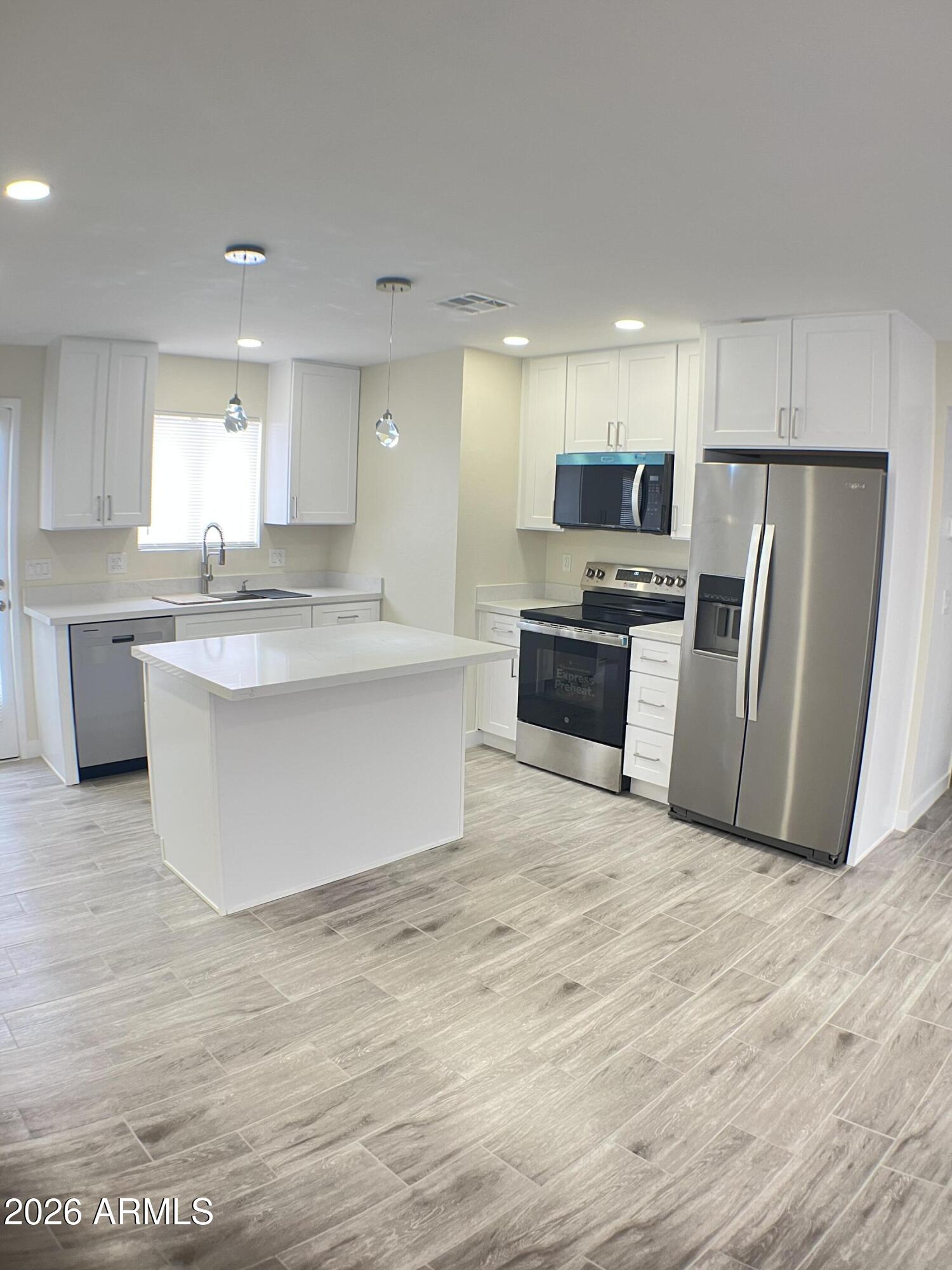 Don't Miss! Beautiful Home! Great Location 3 min to Grand Canyon U. Townhouse not Condo Easy financing!  REMODELED!!!  Open, light and airy, designer finishes. NEW Kitchen White shaker Pro Craft cabinets. 42'' uppers, NEW Whirlpool Appliances, NEW water heater, NEW Custom Quarts Countertops. NEW Spa like bathrooms. New Tile floors, tall baseboards, NEW fixtures throughout. Nothing left for you to do! Just move in and enjoy! Large. Master w/walk in closet, Private Fenced and gated yard updated great for BBQ or just lounging. Hard to find 2 covered parking spaces right next  your  gate. Others have one space often far from your door! Beautiful community pool. Large exterior storage! Quick access freeways, I-17, I-10, 202  Low HOA. GCU Staff or Student (Parents) buy this Townhouse! Why Rent?