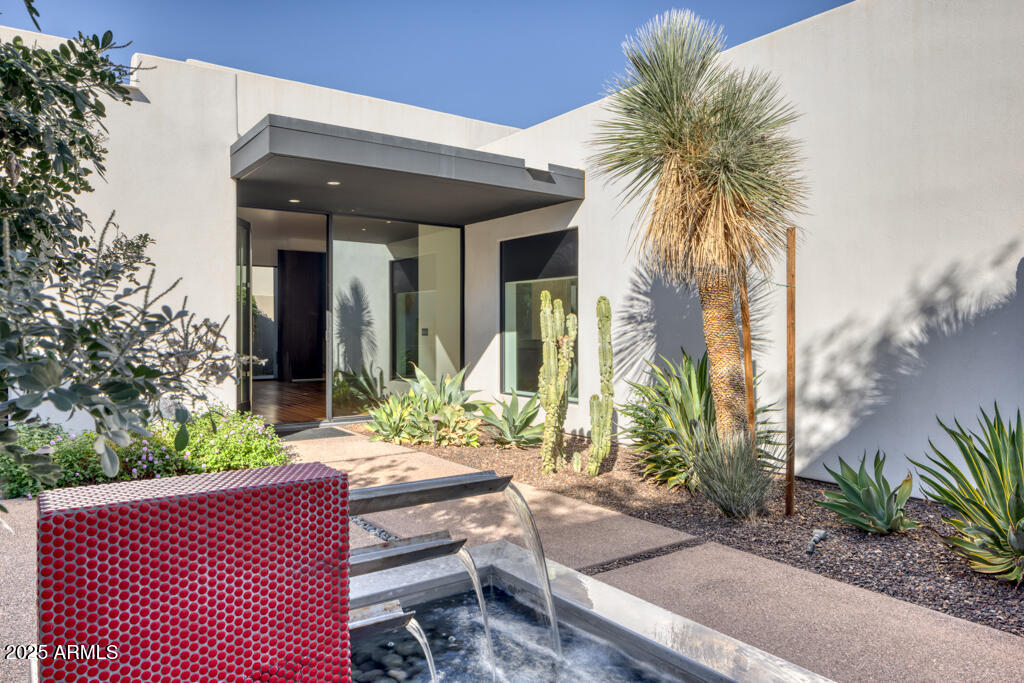 Rebuilt in 2010, this freshly painted, contemporary residence in the coveted, guard-gated community of Colonia Miramonte is a must see. The neighborhood's name translates to ''Colony with a Mountain View,'' and stunning views of Camelback Mountain can be enjoyed from the main home and 2-bedroom casita. Engineered walnut floors add a sense of warmth, while large windows let in an abundance of natural light. The spacious kitchen features quartz countertops, Wolf & Sub-Zero appliances, a wine fridge, and a beautiful view of Mummy Mountain. The primary includes an oversized closet and walk-in shower. A separate casita entrance can be found in the private courtyard where a lovely water treatment lends its soothing sounds. Enjoy a swim in the community pool and gatherings at one of the many parks for "yappy hour" and occasional acoustic performances. In addition, the Camelback Inn offers discounts and white glove room service! Whether year-round or lock-and-leave, Colonia Miramonte was designed to accommodate your lifestyle. A desert jewel in the heart of Paradise Valley.