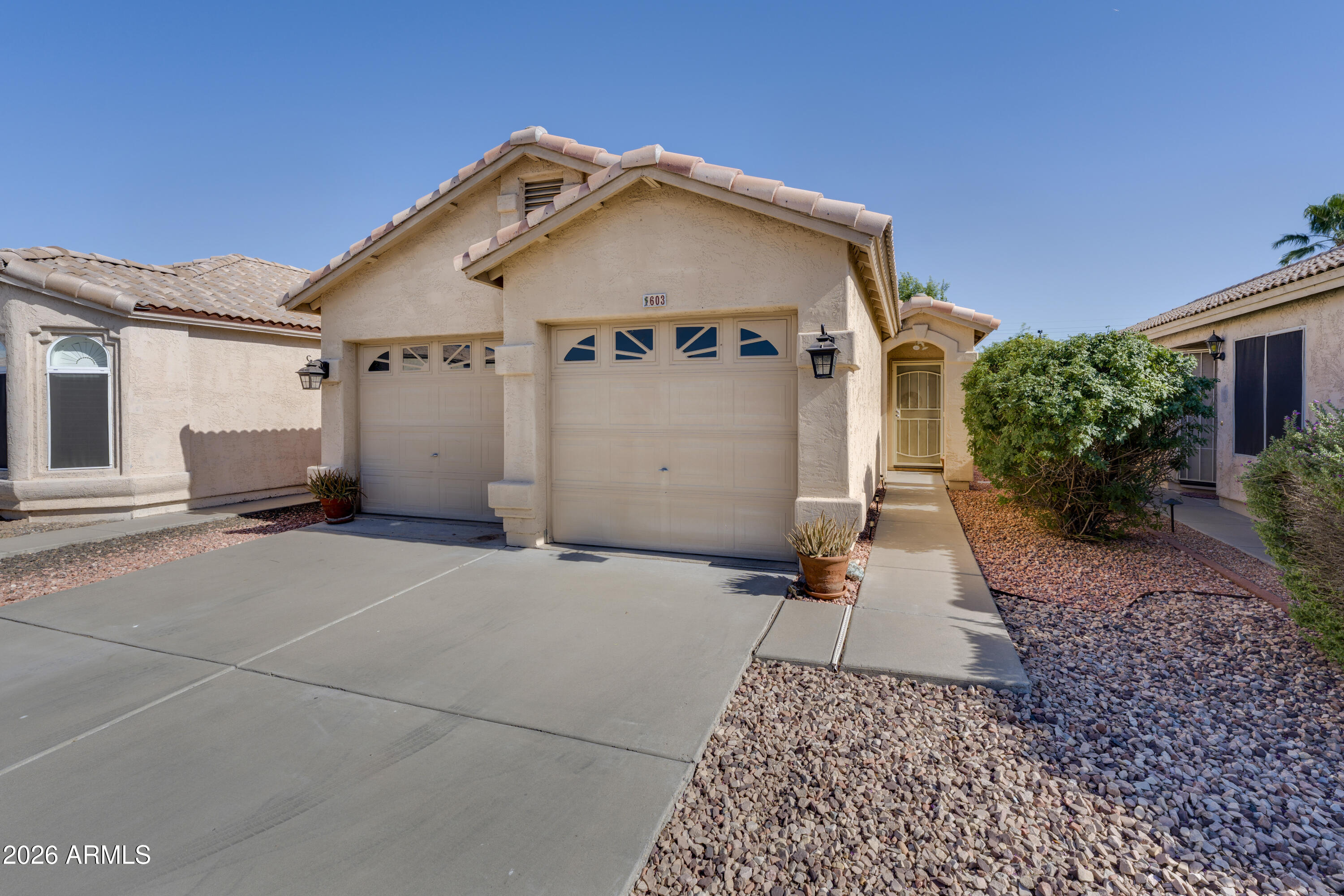 Welcome home to this inviting 3-bedroom, 2-bath charmer with a desirable split floor plan and vaulted ceilings that make the home feel open and bright. Attractive 18'' tile runs throughout, offering a clean, low-maintenance look. The spacious eat-in kitchen features tile countertops and backsplash, stainless steel appliances, and plenty of room to gather. All appliances stay--including washer and dryer--and you'll enjoy the convenience of an inside laundry room and 2-car garage. Outside, relax in your private, low-maintenance backyard with mature landscaping and a covered patio. Enjoy peace of mind with a newer hot water heater and A/C, plus a new $4k split air handler. All this just minutes from the 101 and I-17.