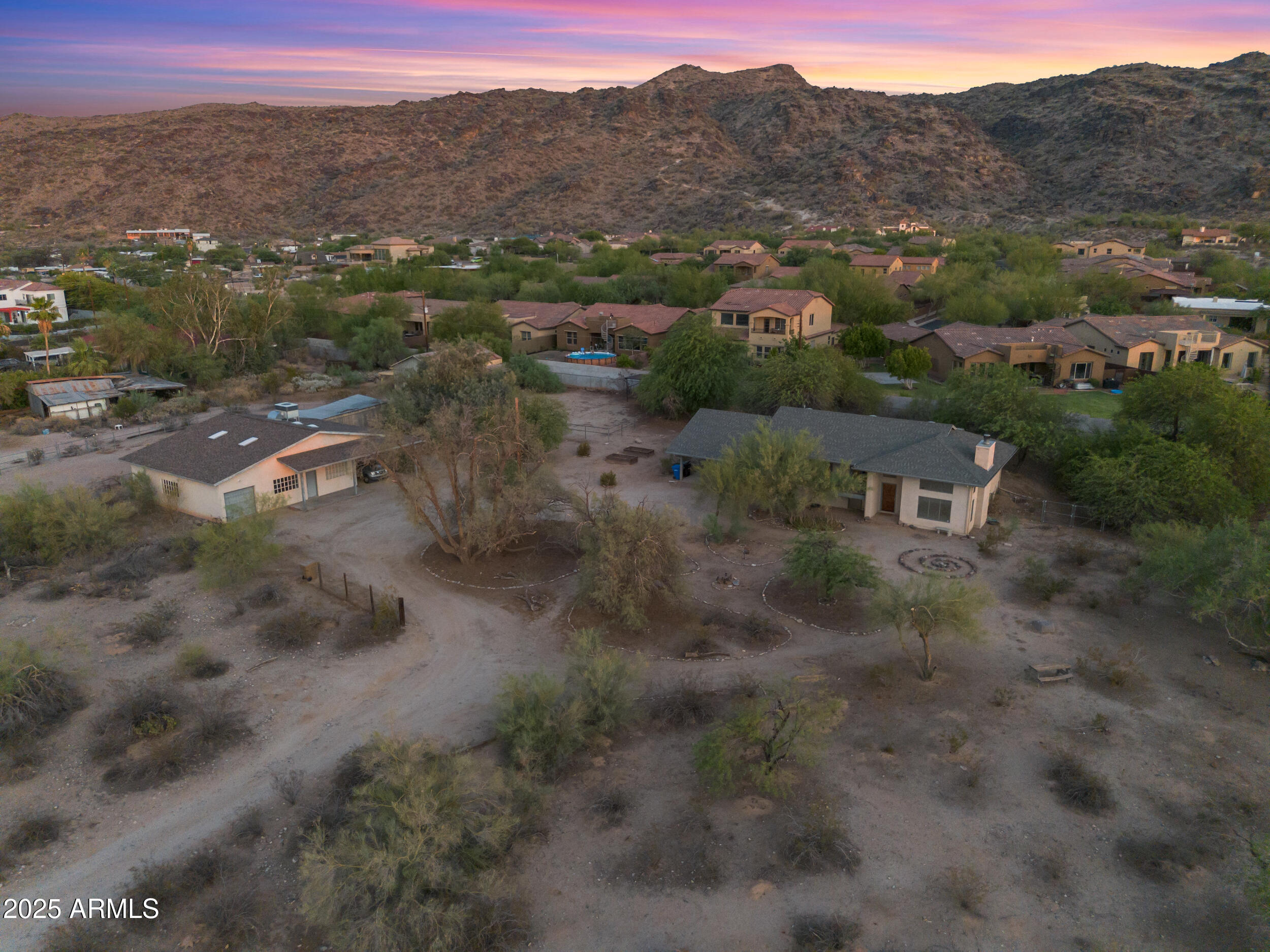 2.27 Acre property with existing house and workshop. Zoned R-16 could be subdivided. Live in the house while building others, convert the 1700 sf workshop to a home! Views of South Mountain and Camelback. Beautiful city light views, sunrises and sunsets! NO HOA! Quiet peaceful desert setting on the base of the mountain! Centrally located close to airport, ASU,down town, east and west valley! The possibilities are endless!