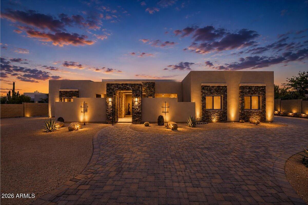 This stunning custom home, completed in 2024, sits on a private 1.1-acre lot with **No HOA**--a true oasis for enjoying Sonoran Desert living. Designed with both elegance and comfort in mind, the 4-bedroom, 3.5-bath layout includes a dedicated office and a thoughtful split floorplan that enhances privacy and flow.
The spacious Great Room features a fireplace and opens seamlessly to an exceptional kitchen equipped with top-tier stainless steel appliances and slab-quartz countertops. The luxurious Primary Suite offers plenty of room to relax, along with a spa-inspired bathroom featuring a walk-in shower/tub wet room and an oversized walk-in closet. Expansive sliding glass doors create effortless indoor-outdoor living. Travertine pavers extend across the patios and entry courtyard, where two outdoor fireplaces set the scene for enjoying breathtaking sunsets and views of Black Mountain. 
The backyard overlooks a sparkling pool, perfect for desert evenings.
A long, gated private drive with a circular turnaround ensures peace and seclusion. Additional highlights include a 4-car garage with ample storage.  
**Furniture available under a separate Bill of Sale. **