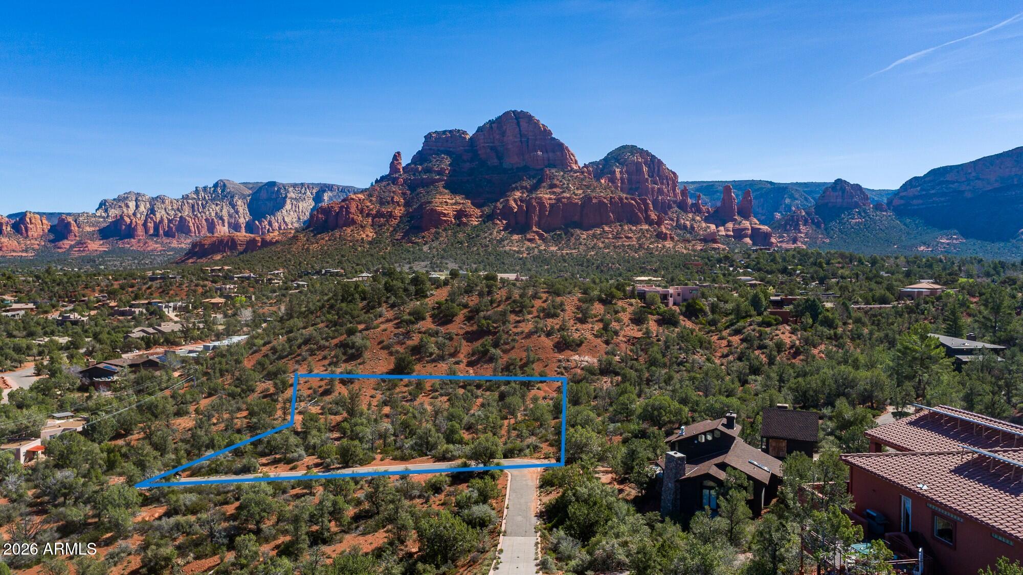 Nestled in the red rocks of Sedona's Chapel Area, this pristine 1.01-acre parcel boasts stunning panoramic red rock views in every direction. The tranquil property is just minutes from Sedona's infamous Art Districts & fine dining, yet its Chapel location is known for peaceful quiet, exhilarating red rock views, fantastic trails & stunning sunrises/sunsets. This rare find is a prime location for building your dream home. There is no HOA nor CC&Rs, so you can follow City building codes, which allow short- & long-term rental as well as multi-units. APS electricity & private water company utilities are one block away. It is a 5-minute walk to the Coconino National Forest, where trails lead to Chavez Crossing, a magical red rock wonderland on Oak Creek where you can swim, fish, sunbathe on red rock platforms, or hike along the Creek in the shade of tall sycamore and cottonwood trees. The property is graced with ancient pinyon pine, juniper trees, and lovely native flowers and shrubs, creating opportunity for nature wandering right on your own land. Wildlife abound in this area. Your brand new build can take advantage of the huge Sedona red rock views. The property is on a paved road and has a paved drive on the west border, which is shared with the neighboring property. Sedona Fire District Station 6 is located just 4 minutes away on Highway AZ-179 and Sky Line Drive. Highway AZ-179 has nice, safe sidewalks and bike paths for easy access to shops and restaurants. It's a 15-minute bike ride to Tlaquepaque, a famous outdoor artisan mall located in a shady Oak Creek riparian area adjacent Uptown Sedona Arts District. Along the way from the property to Uptown, there are galleries, shops, restaurants, pubs, and ample outdoor sculptures, stained glass, and artisan wind pieces to dazzle the eyes of any art enthusiast. In the photos, see the talented artist/land owner's rendering of the home they had planned to build on the property. The premium Chapel area is one of Sedona's most desired locations and is home to the infamous Chapel of the Holy Cross, built right into the red rocks on Coconino National Forest land. It is listed as one of "the most beautiful churches around the world," by Architectural Digest. The breathtaking, world-renowned beauty of Sedona is captured perfectly on this unique parcel. There is no constraint on build time, so buy now and design your dream home later. This gorgeous parcel is a rare find. The Chapel area is known for beautiful, unique luxury homes, many priced in the multi-millions. The native trees & lush vegetation on the property are considered part of a remnant Chaparral ecosystem, leftover from when Sedona was a great, shallow ocean 330 million years ago. You can still find seashells on the limestone ledges & in the red soil. Sedona, Arizona is located within the Verde Valley American Viticulture Area (AVA), where the climate and soils are known for slowing the maturity of the wine grapes, extending the growing season, and leading to more complex wine flavors. Our abundant wine country is growing in popularity and may one day be world-renowned. This is a rare opportunity to enjoy vast Sedona red rock views from your custom retreat for decades to come. Arrange for your private tour today.