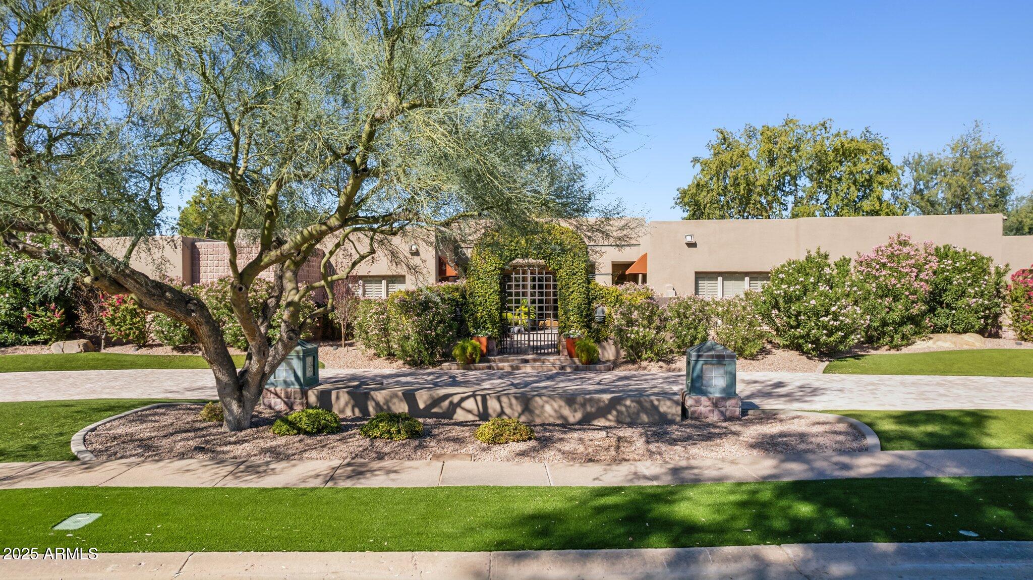 Welcome to Vaquero, 
an exclusive gated community located in the prestigious master-planned Gainey Ranch. This exceptional estate sits on over an acre of meticulously manicured grounds, adorned with mature shade trees and tropical vegetation. The expansive backyard is designed to enhance privacy while providing a peek of Scottsdale's 
iconic McDowell Mountains and pristine fairways of the premier Arroyo Golf Course. 
Extensive paver patio and decking surrounds the sparkling pool and BBQ area, perfect for outdoor gatherings. Enter the home through a charming garden archway and step into a space that seamlessly combines elegance and warmth. Soaring ceilings and large windows flood the open living areas and formal dining room with natural light, while a cozy sitting room provides a quiet retreat. Gorgeous wood and stone floors lead to the luxurious primary suite with his-and-hers closets & an exercise room. A beautiful kitchen with a Dacor gas range, double ovens and Sub-Zero refrigerator overlooks your tranquil backyard oasis. The west wing offers a versatile space for use as a private guest suite, entertainment room or personal art gallery. The parking garage spans over 1,300sqft, complemented by a sprawling parking court with room for more than a dozen additional vehicles. Installed Generac 60W standby generator with automatic backup services the entire home. Gainey Ranch is renowned for its exquisite blend of peace and opulence with 27 holes of golf, 24/7 security, pool, state-of-the-art fitness center, pickleball and tennis courts. All of this is located in the heart of Scottsdale, ranked among the most desirable cities in the nation.
