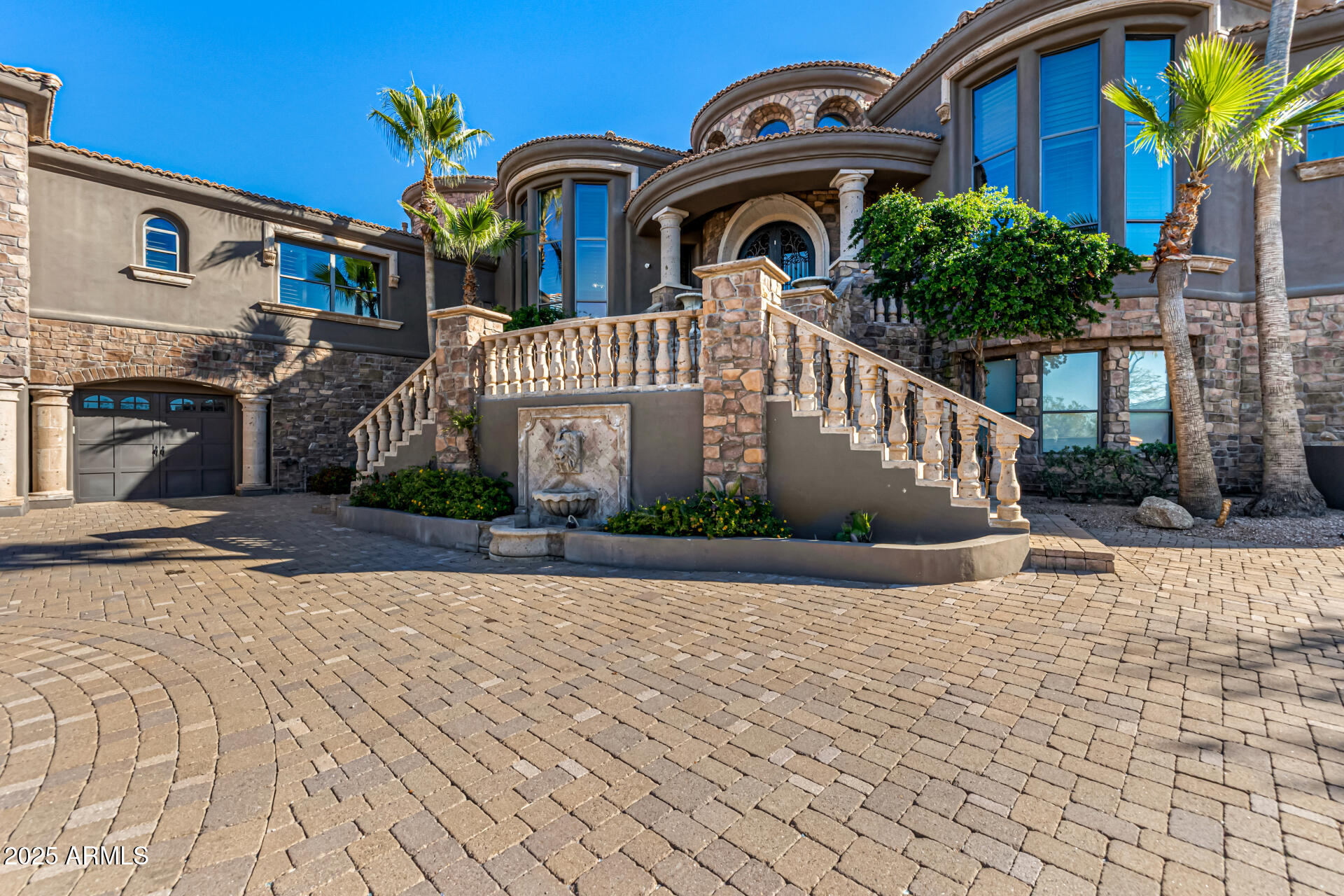 Prepare to be amazed! Scenic views abound at this 6 bedroom 9 bath privately gated estate now for sale in Pinnacle Vista! Nestled on a HUGE 3.8 acre cul-de-sac lot w/fantastic mountain views, this wonderful abode also boasts tasteful stone accents, a manicured desert landscape, an 8-car garage w/built-in cabinets and a paver driveway. Come inside to discover a circular foyer w/stylish column, which flows seamlessly into a formal dining room w/a fireplace, perfect for hosting a dinner party! High ceilings, travertine stone flooring, plantation shutters, dazzling light fixtures, and trending palette throughout. Continue into the spacious great room, showcasing a 2nd fireplace, built-in entertainment niche, pre-wired surround sound, and a wet bar w/an adjoining wine cellar. The gourmet kitchen is worthy of a chef, comprised of wood cabinetry w/crown moulding, granite counters, tile backsplash, stainless steel appliances, 2 farmhouse sinks, a walk-in pantry, a center island w/a breakfast bar, and a breakfast area. Double doors open up to a cozy den, ideal for an office or reading nook! You'll love the grand primary suite, featuring a 3rd fireplace, another wet bar, direct outdoor access, a carpeted walk-in closet, and a lavish ensuite w/dual vanities plus a jetted tub. Don't forget about the large bonus room w/a 3rd wet bar, where you can spend quality time w/friends & loved ones. The guest quarters also include a sizeable living area w/a kitchenette plus a 4th and final fireplace! Film enthusiasts will also be delighted to find a home theater w/yet another wet bar. Lastly, the resort-like backyard includes a covered patio, extended paver seating areas, a lovely gazebo, a pergola w/a built-in BBQ, fire pit, artificial turf, a tennis court, and a sparkling blue pool/spa combo w/a rock waterfall! This is the opportunity of a lifetime, don't let it get away!