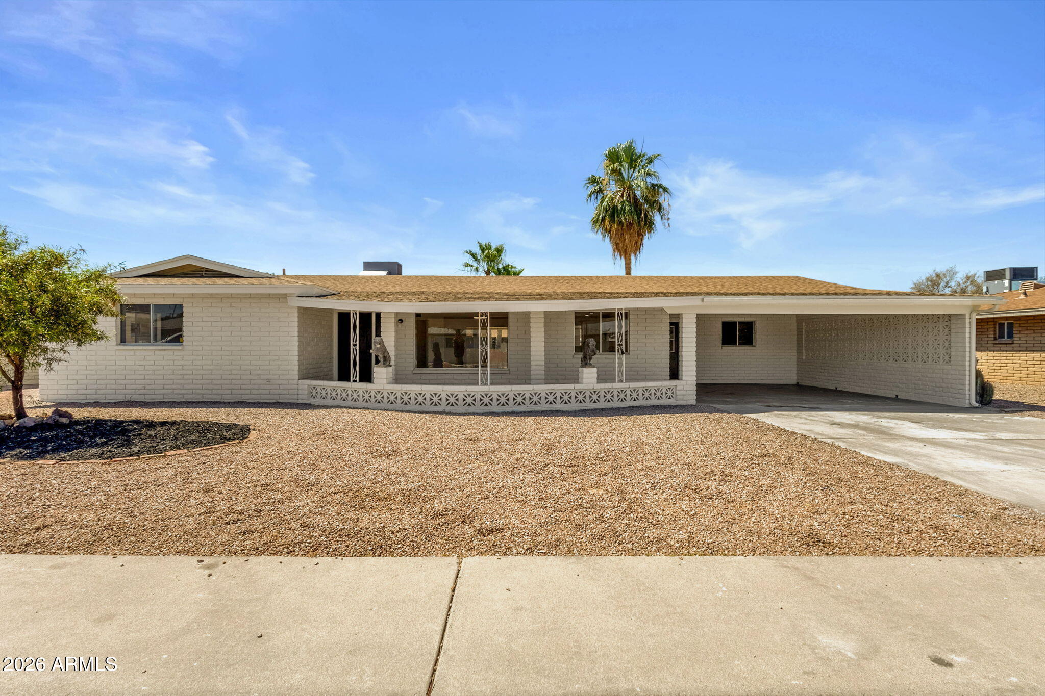 Completely renovated Mesa home with modern designer finishes, expansive covered outdoor living, and a spacious open-concept layout. This move-in ready property features luxury wood-look flooring, recessed LED lighting, and a bright neutral palette throughout. The redesigned kitchen showcases white shaker cabinetry, quartz countertops, stainless steel appliances, oversized island seating, black hardware, farmhouse sink, and contemporary pendant lighting. The split floor plan offers generously sized bedrooms and beautifully remodeled bathrooms with custom tile surrounds, upgraded vanities, matte black fixtures, and spa-inspired finishes. The primary suite includes a large ensuite bath with walk-in shower and modern floating-style vanity. Spacious indoor laundry/storage room adds flexibility and functionality.
Enjoy Arizona living year-round under the oversized covered front patio and extended covered backyard patio overlooking the large low-maintenance yard with mature palm trees and desert landscaping. Covered parking plus extended driveway provide ample parking space.
Located near golf courses, parks, shopping, dining, Banner Baywood Medical Center, US-60 access, and everyday conveniences in East Mesa. A beautifully updated home blending modern style with comfortable single-level living.