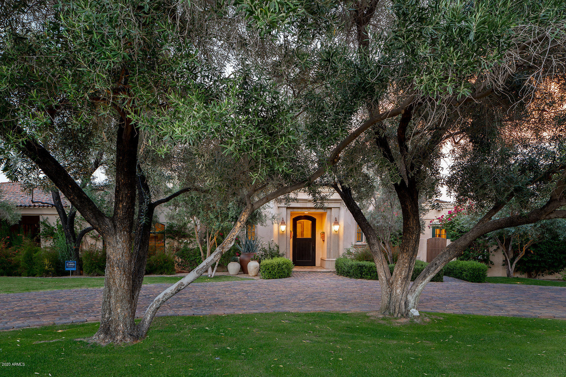 An incredible value and move in ready!
Located in the gated community of Clearview Edition and sited on a large corner lot; lush and mature landscaping frame this sprawling residence.  A mud set clay tile roof, tiled circular driveway and decorative carved stone accents are a few of the design details defining the authentic Santa Barbara architecture.  A light filled entry foyer welcomes guests to take in the spectacular view of Camelback Mountain through the great room's wall of French doors.  The temperature-controlled wine room and wet bar are just down the steps, perfect for entertaining. Beamed ceilings, multiple fireplaces, solid wood and stone flooring, and a very gracious floor plan give this home a feeling of permanence.  The master wing includes a home office with its own courtyard,  a true "his/hers" master bath, a light filled gym, and a tranquil bedroom.  There are four additional en-suite bedrooms in the main house, all generously sized.  A chef's kitchen with a large center island opens to a breakfast banquette and a fabulous family room; with its wall of French doors to the patio on one side, and a two-way fireplace on the other.  A formal dining room and butler's pantry as well as a beautifully decorated powder room.  A guest casita has a full kitchen and is built with the same level of fine finishes as the main house.  Outdoors are beautiful grounds you will want to spend all of your time in.  Multiple patios, grassy play yards, beautiful pool,  firepit, built-in BBQ and  a pizza oven too!