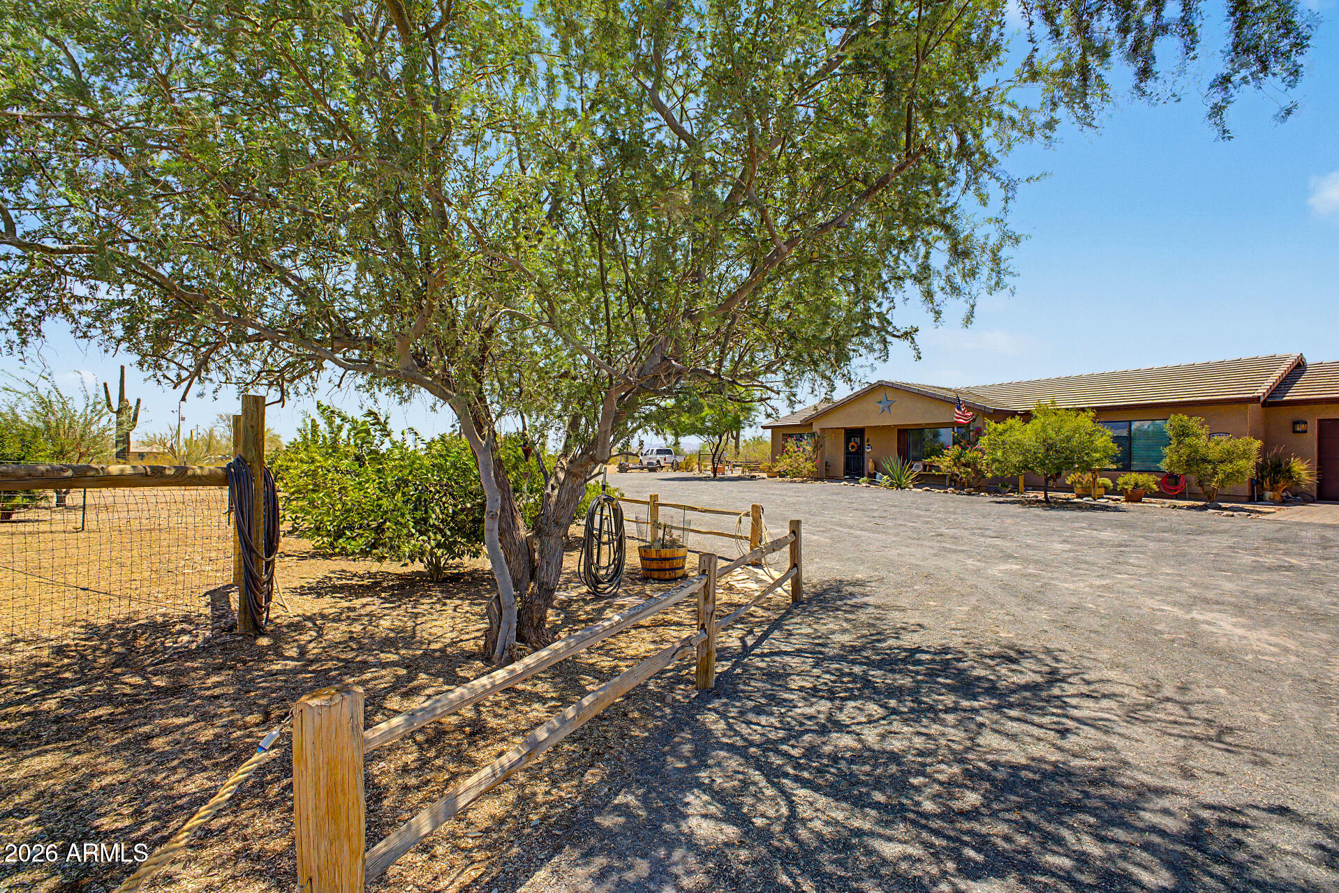 A private desert oasis & hobby farm where sustainable living meets modern comfort.  Exceptional home w/hobby farm features a thriving orchard w/multiple citrus, apple, peach, fig, pomegranate, quince & mulberry trees, raised/covered garden beds, a wireless automated watering system & a fenced animal village, chicken coop w/watering and wifi mister system, rosella hibiscus, & herb gardens.  Ample shade trees w/split-rail landscaping, play area & Pergola in private backyard for relaxing & enjoying the amazing AZ sunsets and a fire.  Dual RV hookups include 30-amp service on the north side & 50-amp, 110V, water, & sewer dump on the south.  Home offers an open split floor plan, covered patios, large pantry & laundry, plus circular drive and fencing around the entire property. List of Trees: 
Orange, Blood Orange, Mandarin, Clementine, Fig, Anna Apple, Peach, Lemon, Limes, Mexican Limes, Grapefruit, Tangerine, Apple, Quince, Pomegranate,  Mulberry, Arizona Ash, Mesquite, Chinese Elm, Palo Verde, Ironwood, Samuel Ash and more!!

Great property for Farm stand business or potential for conversion to horse property.