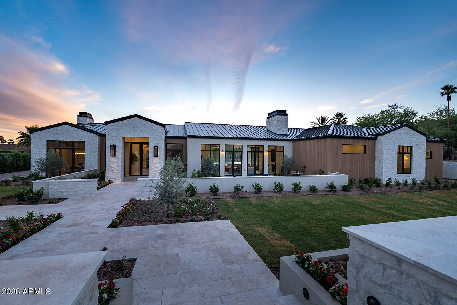 Introducing the newest development from Travis Custom Homes, SMITH and Kozi Design in Paradise Valley, an exceptional nearly 7900 SF estate inspired by the hills of Montecito. Featuring 5 bedrooms, 6.5 baths, an office, bonus room, and dedicated TV room, this home blends luxury with an organic, timeless feel. Rich stone and dark wood elements pair with exposed beams and tongue-and-groove detailing throughout. Entertain effortlessly in the large kitchen featuring two huge islands and has seamless indoor/outdoor flow. The resort-style backyard offers a pool and spa, fireplace and private championship style pickleball court. Complete with a massive 5-car garage and fully livable 1 bed, 1 bath guest house.