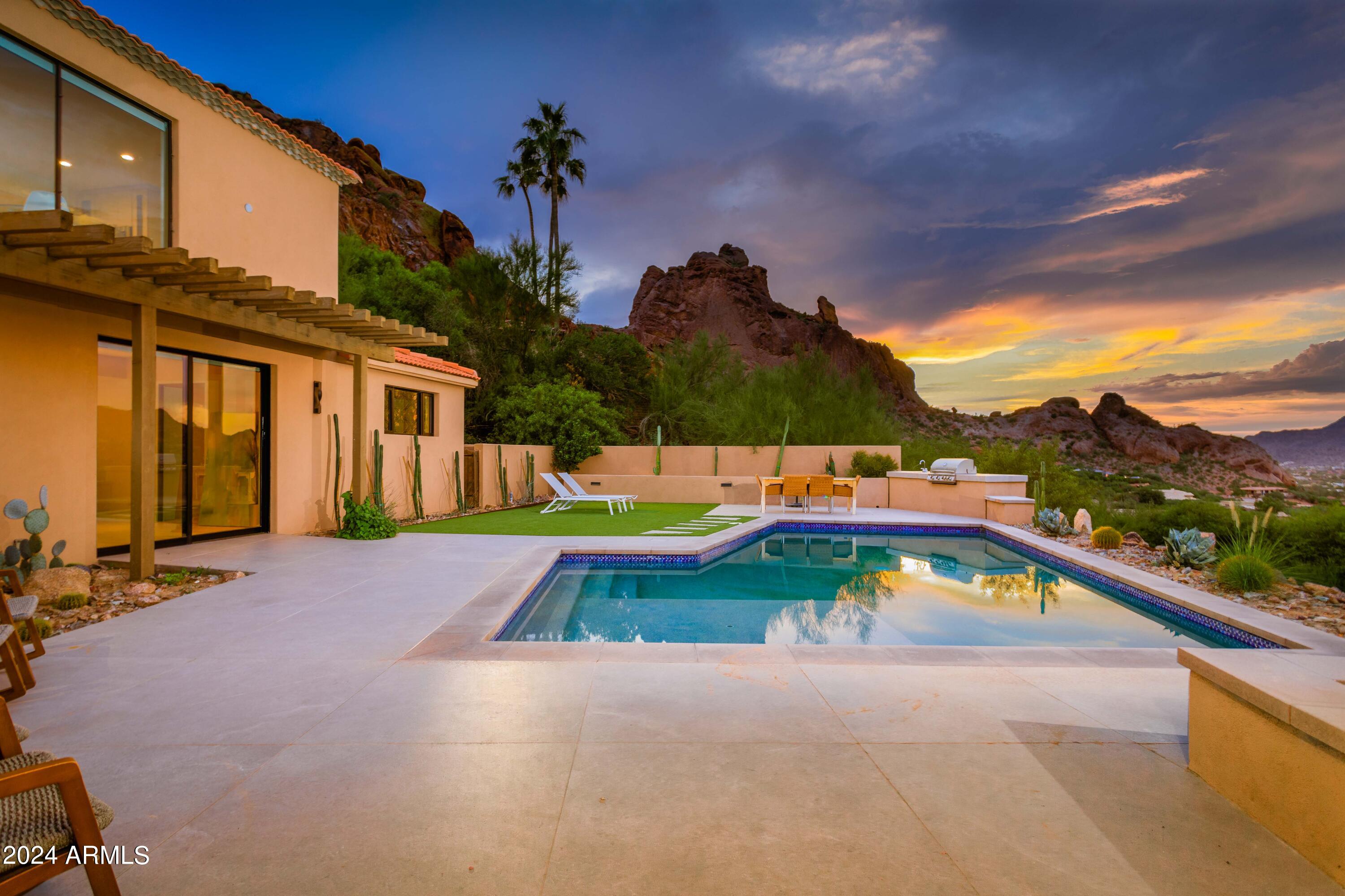 Magical, Modern, San Miguel PV Hillside Luxury Home that boasts BEST VIEWS, bar none. From Praying Monk so close you could touch it to Mummy Mountain majesty as lights twinkle on, you won't miss anything here. COMPLETELY remodeled, this classic home envelops you in luxury with a clean line aesthetic, crisp whites, warm woods & magazine baths. Primary Suite is a SPA unto itself, literally. CASITA has complete kitchen, ensuite and laundry so, your guests can stay a while & have independence. Main house oozes all you want and earns bragging rights with an open great room, indoor-out living & entertaining concept, multiple dining zones, fireplaces, pebbletec pool/sauna/spa, fleetwood doors and a kitchen set up for a gourmet cooking class. Breathtaking! See Supplement for MORE! Breathtaking Views of Camelback & Mummy Mountains
Paradise Valley Luxury Location
FULLY Remodeled Top to Bottom
Modern & Clean Warm Aesthetic
Full Casita Attached w/ Kitchen, Bath, Laundry
Main House is Open w/ Gracious Spaces
Great Room Orientation to ALL VIEWS
Pool PebbleTec & Perfection for Night Lights
Traditional Styling meets Modern Living
Exceptional Kitchen Amenities & Space include: 
Drawers, Storage, Commercial Vent Hood
Wolf Double Oven w/ Gas 8 Burner Cooktop
Electrolux DishDrawers, Subzero French Fridge
Low Maintenance Colorful Desert Landscaping
Impressive Uplighting throughout
Built In BBQ, Firepit, Seating Galore on Decks
Gas Fireplace in Family Room
Light Wide Plank Wood Flooring
Primary Suite has all of the Luxuries of a SPA:
Massive Walk In Shower, Multiple Heads
Soaking Tub & Heated Sauna
Fleetwood Doors Throughout
Guest Ensuite with/ Rain Showerhead
Best Praying Monk View around