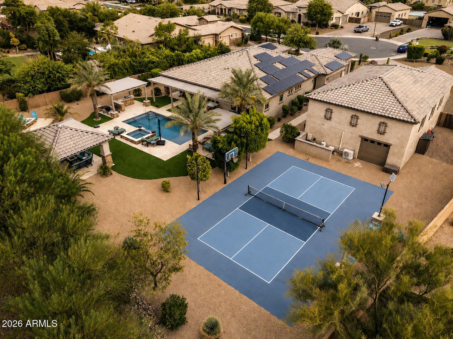 Why book a 5-star resort when you can own one? Welcome to one of the area's most exceptional luxury estates, where every day feels like a vacation. From the $250,000 resort-style backyard and the 2,900+ sq. ft. RV garage to the paid-off 30kW solar system, breathtaking 22-foot rolling glass wall, 50-foot RV gate, 24-foot RV gate, and spacious 4-car garage, this home delivers a level of luxury, functionality, and entertainment that's nearly impossible to recreate today.

Featuring 3 bedrooms plus a dedicated office, with approved plans to easily convert the home into a 4-bedroom layout, every detail has been thoughtfully designed for both everyday living and unforgettable entertaining.

Inside, the designer chef's kitchen flows seamlessly into expansive living spaces filled with natural light, while the spa-inspired primary suite offers a luxurious private retreat. Recent upgrades include fresh interior paint throughout, beautifully remodeled bathrooms, painted white vanities, new carpet, custom storage systems, an upgraded smart pool system, and a state-of-the-art security system.

Step outside to your own private resort featuring a sparkling pool and spa, pickleball and basketball sport court, built-in backyard misters, a brand-new pergola, fire pit, and multiple outdoor entertaining areas designed for year-round Arizona living.

Car enthusiasts, RV owners, and hobbyists will appreciate the 2,900+ sq. ft. RV garage, 50-foot and 24-foot RV gates, and 4-car garage, providing endless possibilities for RV storage, a car collection, workshop, home gym, or future guest quarters. Approved plans to convert a portion of the RV garage into a fourth bedroom add even more flexibility for future living.

Enjoy virtually no electric bills with the paid-off 30kW solar system, which also generates monthly utility credits. This is more than just a home. It's a lifestyle offering an extraordinary combination of luxury, efficiency, technology, and versatility rarely found on today's market.