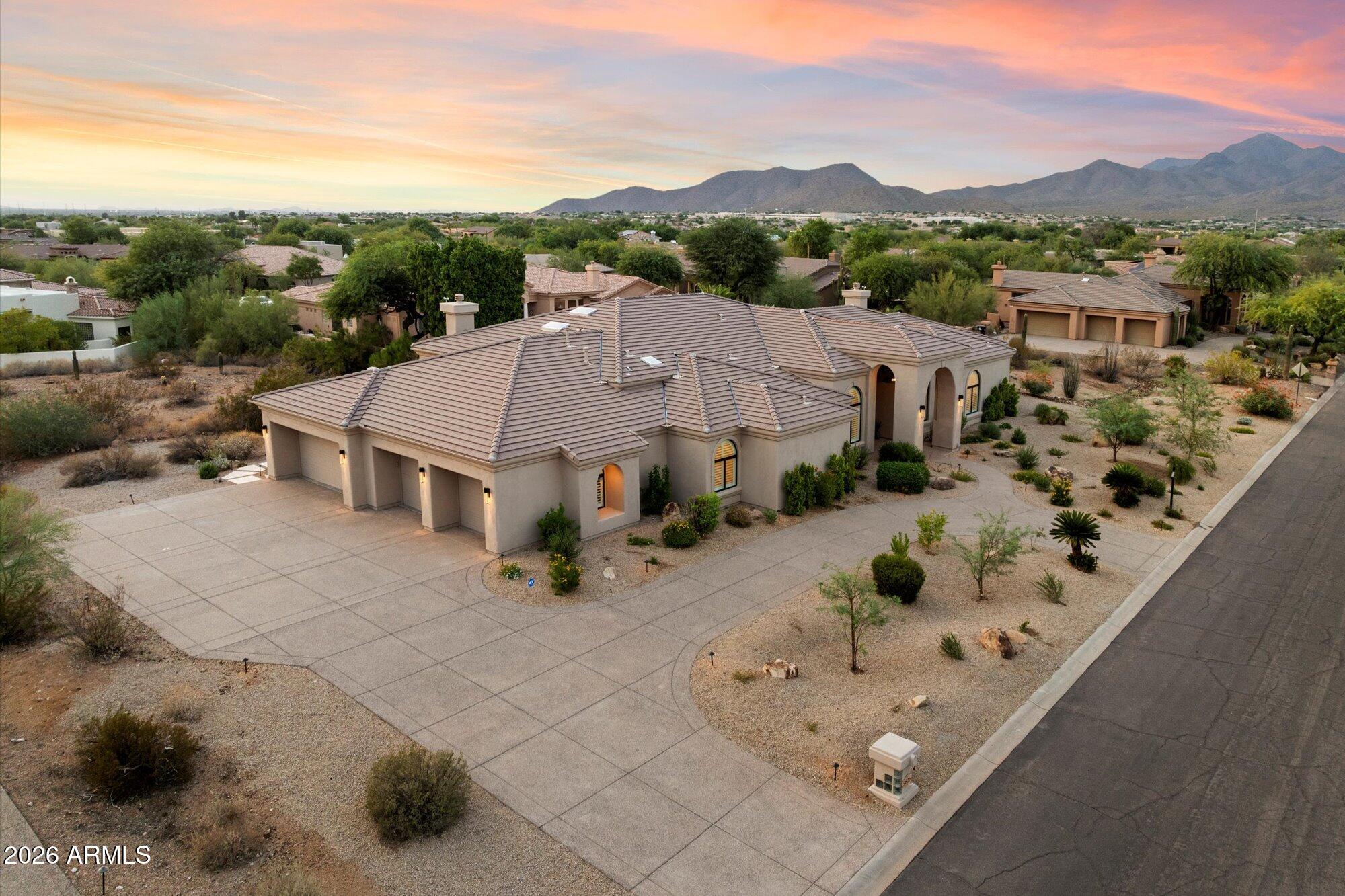Welcome to 9826 N 131st Street, a stunningly renovated luxury estate showcasing modern elegance in the prestigious Catavina community of North Scottsdale. Set on a premier just under one acre lot with panoramic mountain views, this newly completed New Horizon Custom Home offers 4,522 SF of turnkey living with 5 bedrooms, 4.5 baths, and an oversized 4-car garage and is priced WELL BELOW the Sold Comps of total high-end remodels in the area!

Following an extensive 12-15+ month remodel by Lifestyle Lab Design Studio, this single-level residence lives like a brand-new custom home, blending timeless architecture with sophisticated modern design. Vaulted ceilings, wide-plank European oak flooring, expansive hallways, and abundant natural light create an inviting, open-concept floor plan with no interior steps.

The chef's kitchen is designed for both everyday living and effortless entertaining, featuring Wolf and Sub-Zero appliances, White Rhino marble countertops, custom cabinetry, a spacious walk-in pantry, and a pass-through serving window to the outdoor living areas. The luxurious primary suite offers a gas fireplace, spa-inspired bath with dual vanities, freestanding soaking tub, oversized zero-edge shower, and an exceptional boutique-style dressing room.

Designer-selected finishes elevate every space, including custom cabinetry, slab marble and quartz surfaces, statement lighting, decorative tile, custom wall and ceiling details, new shutters, four fireplaces, and premium American-made sliding door systems.

Resort-style outdoor living includes over 3,000 SF of new travertine patios, a redesigned heated pool and spa, contemporary outdoor fireplace, built-in BBQ, putting green, and expansive turf areas.

Ideally located on one of Catavina's most desirable streets, this exceptional property is within walking distance of BASIS Scottsdale and Mayo Clinic, with world-class golf, hiking, dining, shopping, and top-rated schools just minutes away. An extraordinary opportunity to experience the finest in Scottsdale luxury living!