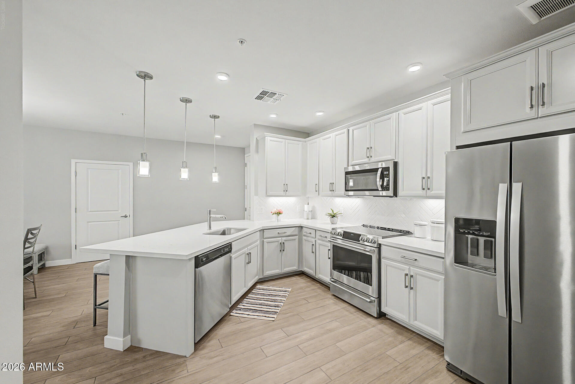 Experience luxury resort-style living in the highly sought-after Downtown Ocotillo lake community. Built in 2021, this beautifully appointed residence features a contemporary open-concept floor plan designed for both everyday living and entertaining.
The gourmet kitchen showcases elegant quartz countertops, 42-inch white Timberlake maple cabinetry, Upgraded ''CAFE'' brand oven range and premium finishes throughout. The spacious primary suite offers a luxurious bathroom and an oversized walk-in closet for exceptional storage.
Step outside to the expansive private balcony and enjoy peaceful lake views, creating the perfect setting for morning coffee or evening relaxation. Residents enjoy an impressive collection of resort-style amenities, including a state-of-the-art fitness center, elegant clubhouse, heated pool and spa, steam rooms, game room, and media room. Just steps from your front door, you'll find some of Ocotillo's finest restaurants, entertainment, cafés, and a luxury day spa--all within walking distance.
Additional highlights include a secure gated parking garage, elevator access to all floors, professional community management, convenient access to the Price Corridor, nearby freeways, and Sky Harbor International Airport just 20 minutes away.